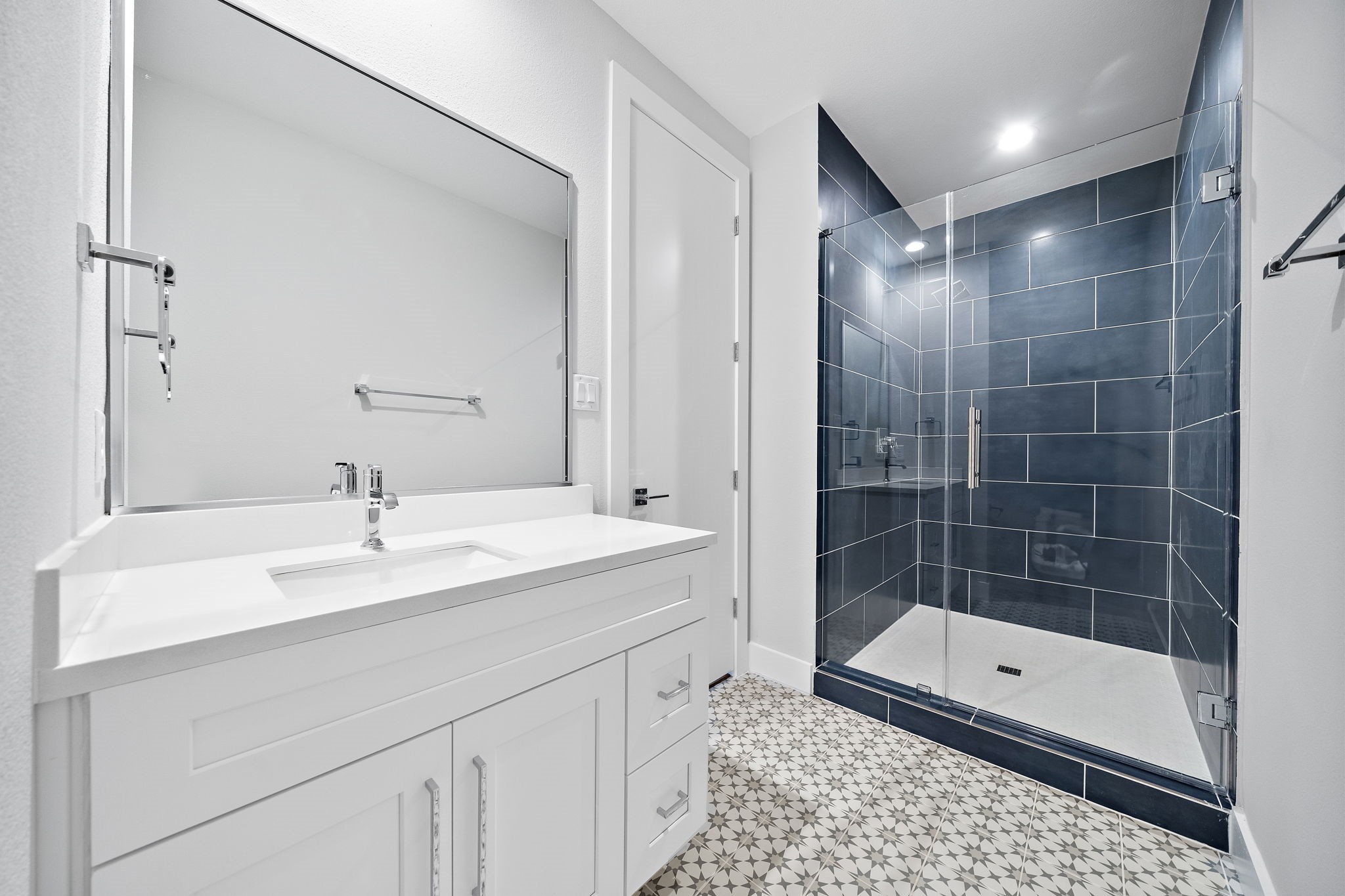 3rd floor ensuite bath with dramatic blue/gray tile.