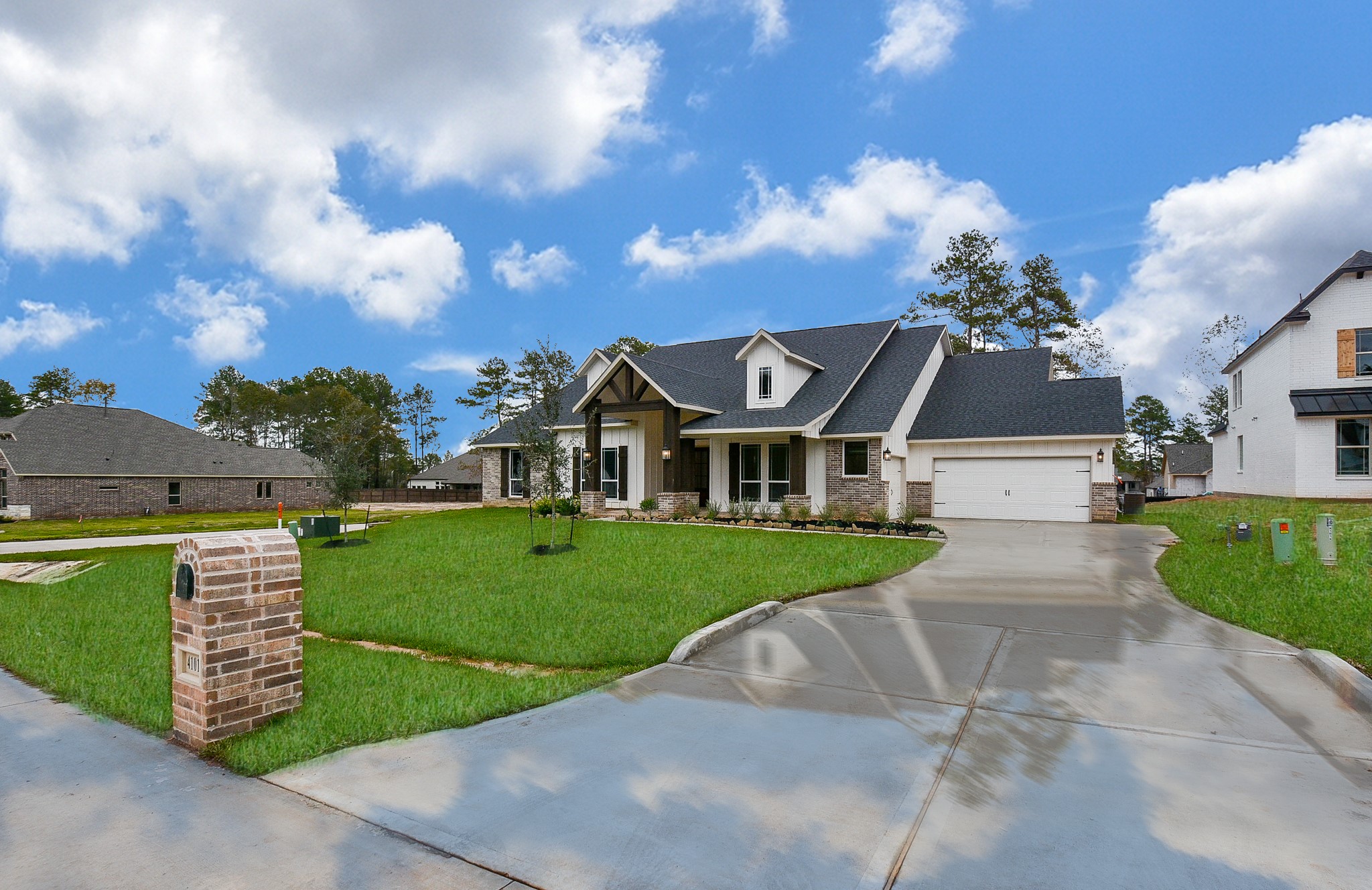 This single family, single story brick gem is located at 41041 Kimber Lane, Magnolia, TX. Pictured here is your easy, pull-in driveway, with room for both family and guest vehicles.