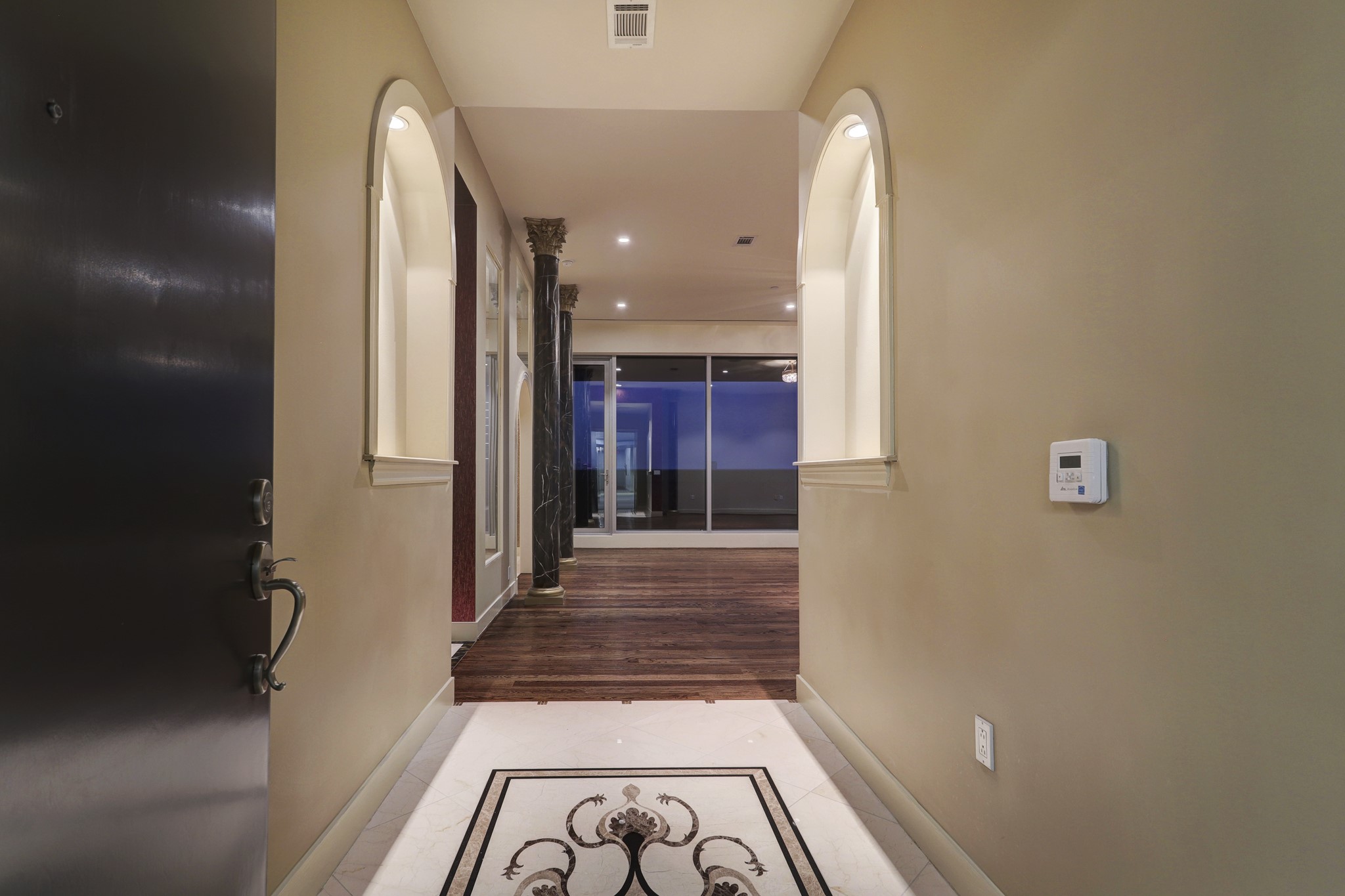 This Formal Entry is one of two entrances into the unit and features repolished marble floor with decorative inlay and two lighted art arches.