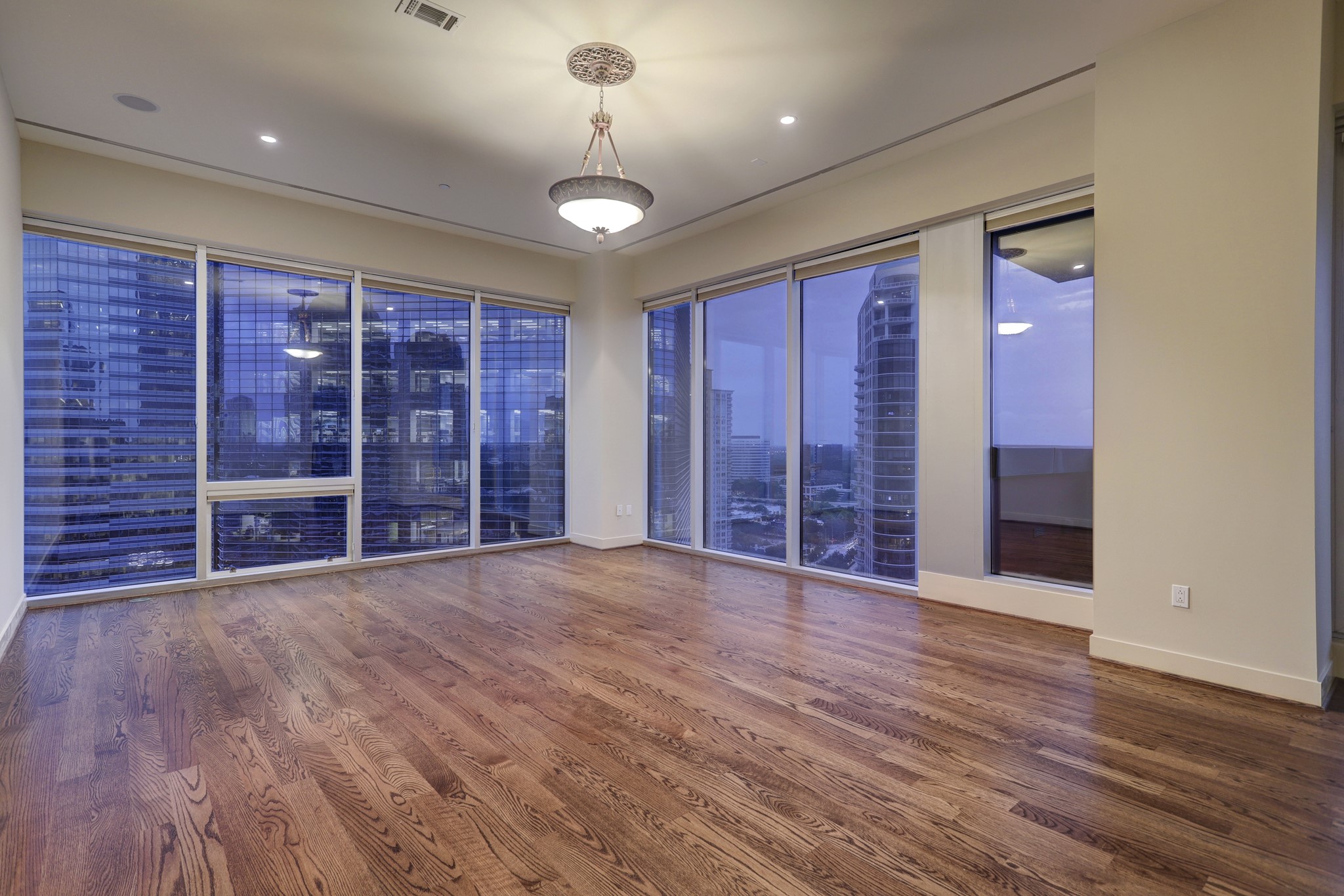 The private Primary Suite [24 x 18] features refinished hardwood floors, wraparound floor-to-ceiling windows bringing in Downtown and Memorial Park views. Direct access to the covered and turfed balcony. A home office is located just off the Primary.