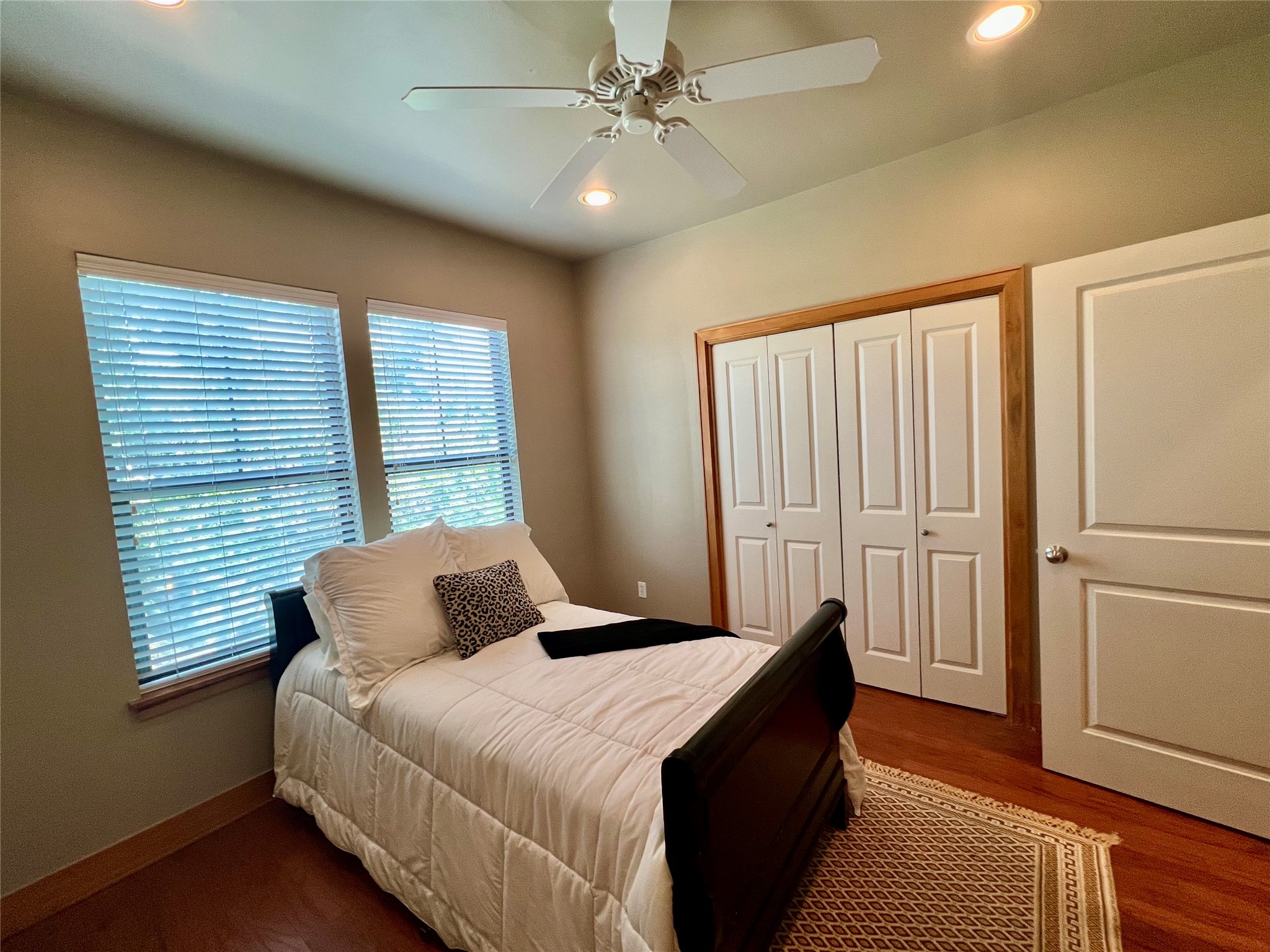 Second bedroom on the third floor with hardwood floors, large closet, private bathroom and recessed lighting.