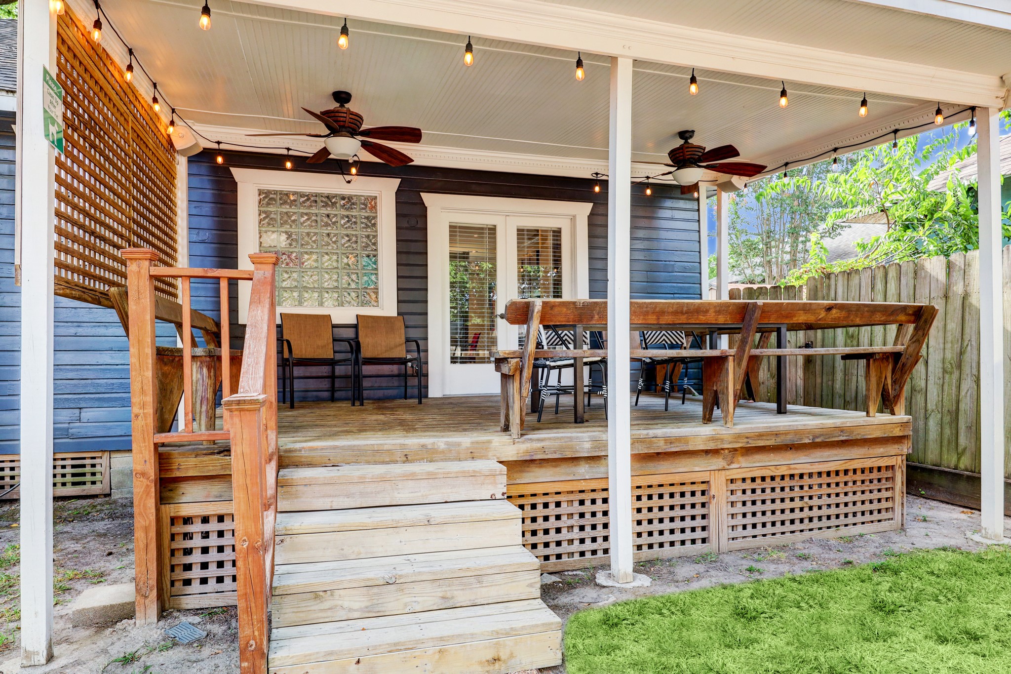 Charming back deck has built-in seating and plenty of room for more furniture.  2 ceiling fans provide a cool breeze and the eastern exposure provides afternoon shade.