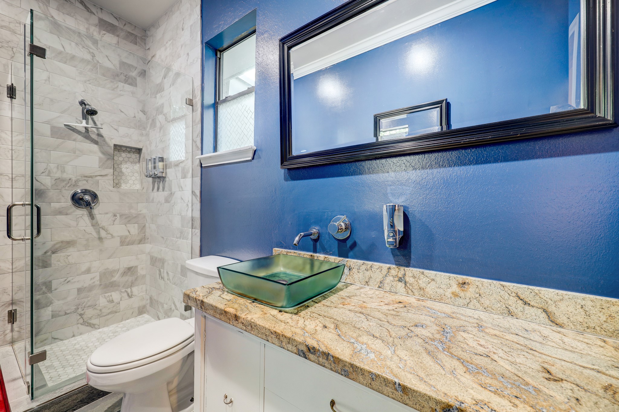 Primary bath updated with standing shower, vessel sink, and large, well-lit closet to hold your wardrobe.