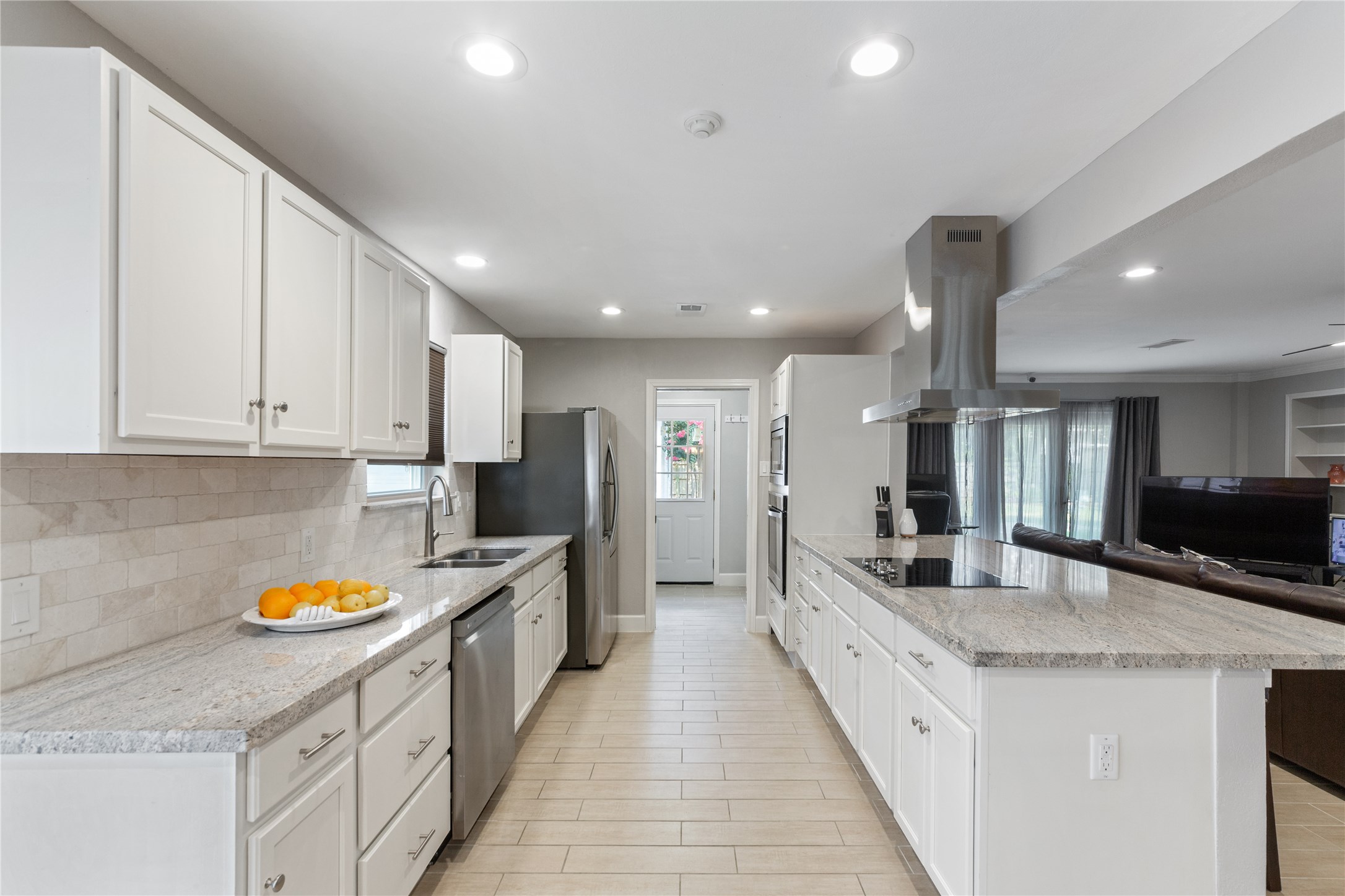 You will love the gorgeous granite countertops.  Stainless steel appliances fit in perfectly along with the overhead venthood which is both useful and beautiful.
