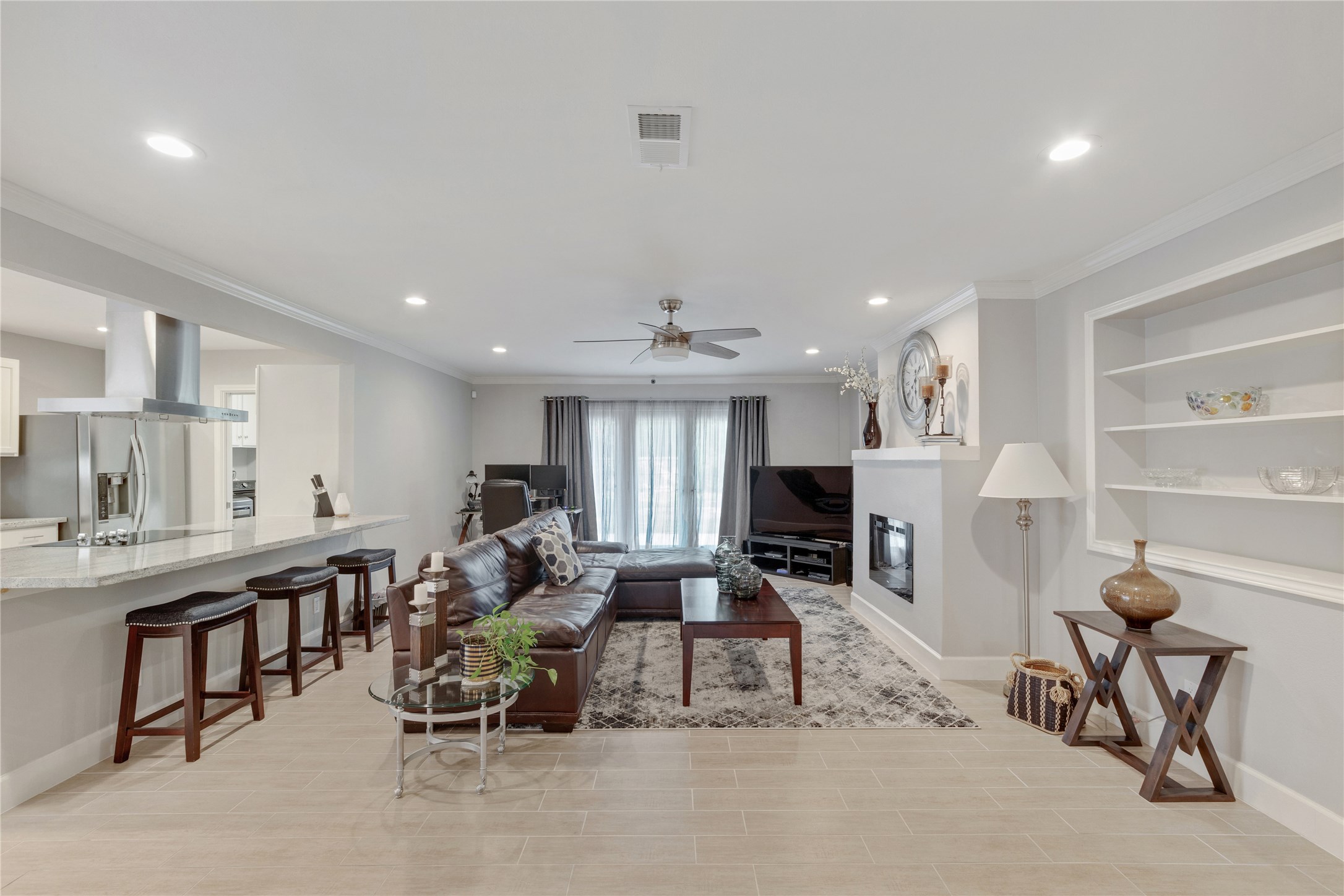 Overlooking the kitchen is the spacious family room with spectacular new fireplace and mantle.  Built in shelving on each side give you ample space for displays.