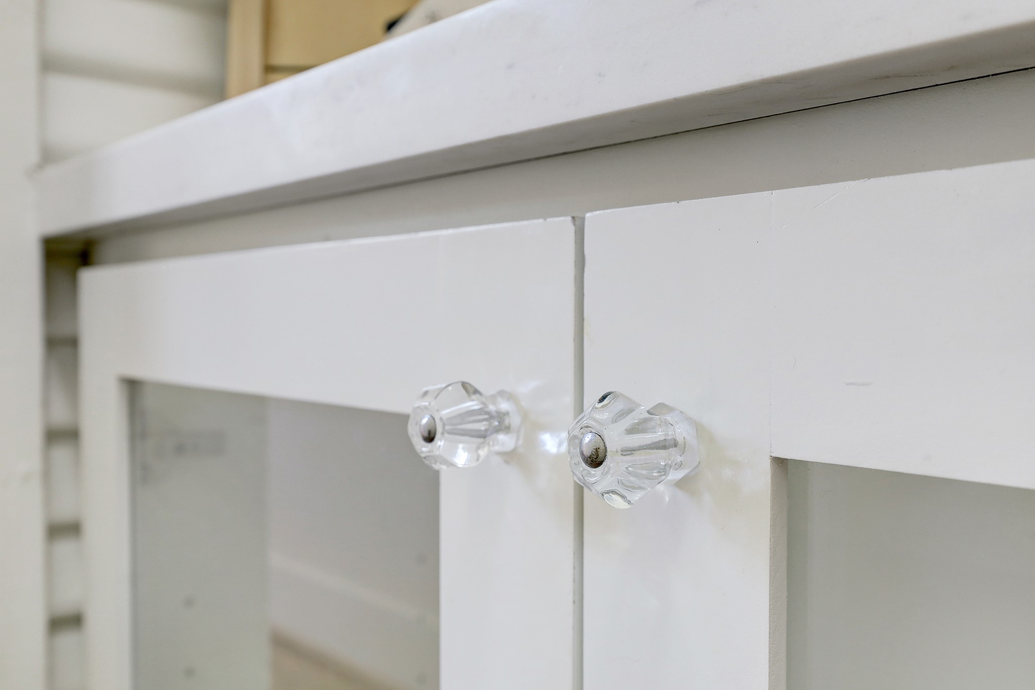 Drawer pulls and finishings selected to match period.