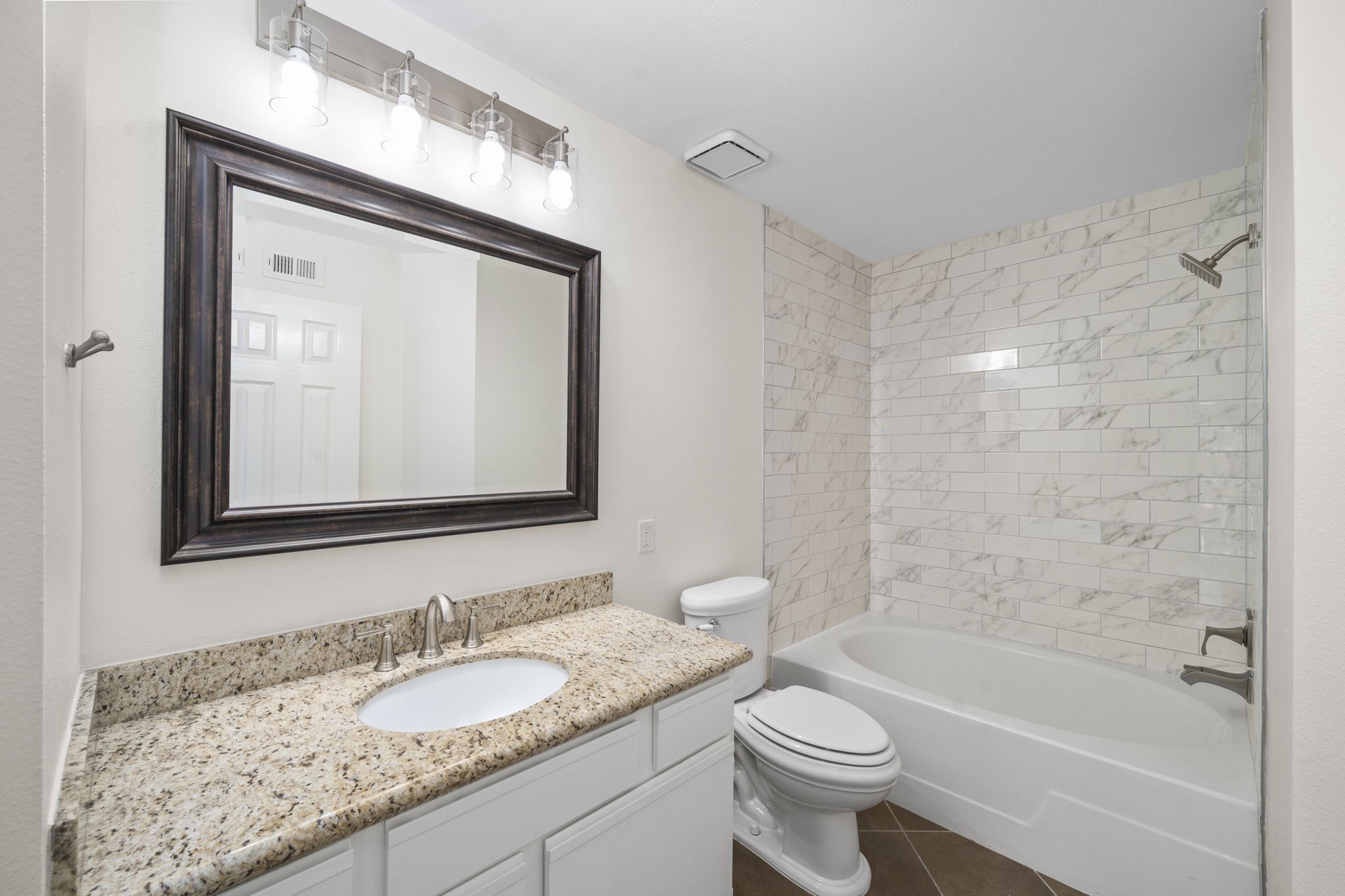 Consistency reigns in the bathrooms, reflecting the unit's overall aesthetic. The cream marble harmoniously complements the white accents, creating a captivating visual synergy.