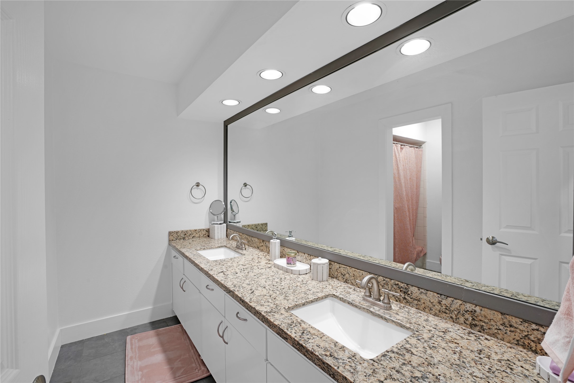 Secondary bathroom upstairs with dual vanities and shower/tub combo. All new lighting throughout the house!