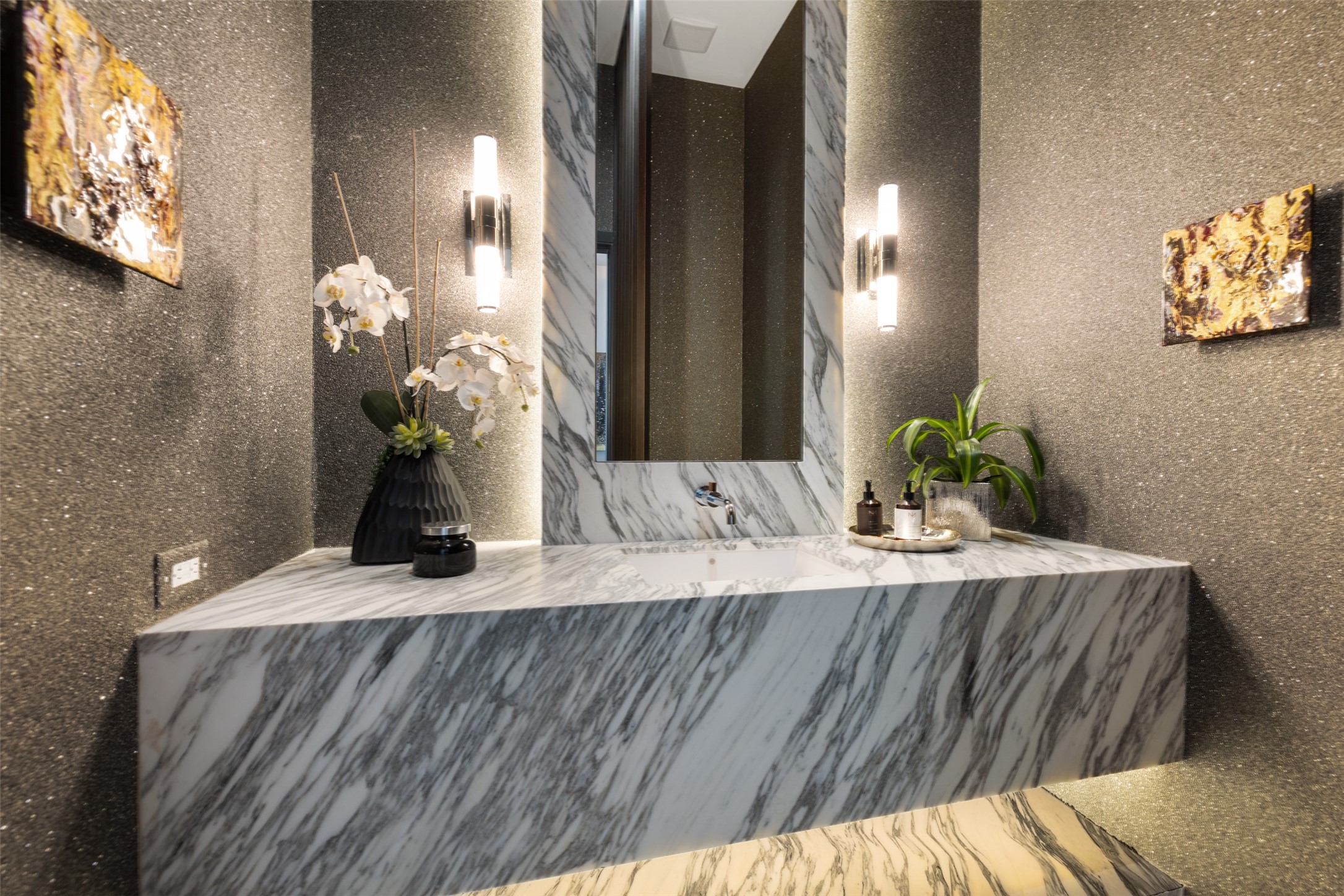 The powder bath is magazine cover worthy from the walls to the marble block counter to the designer lighting.