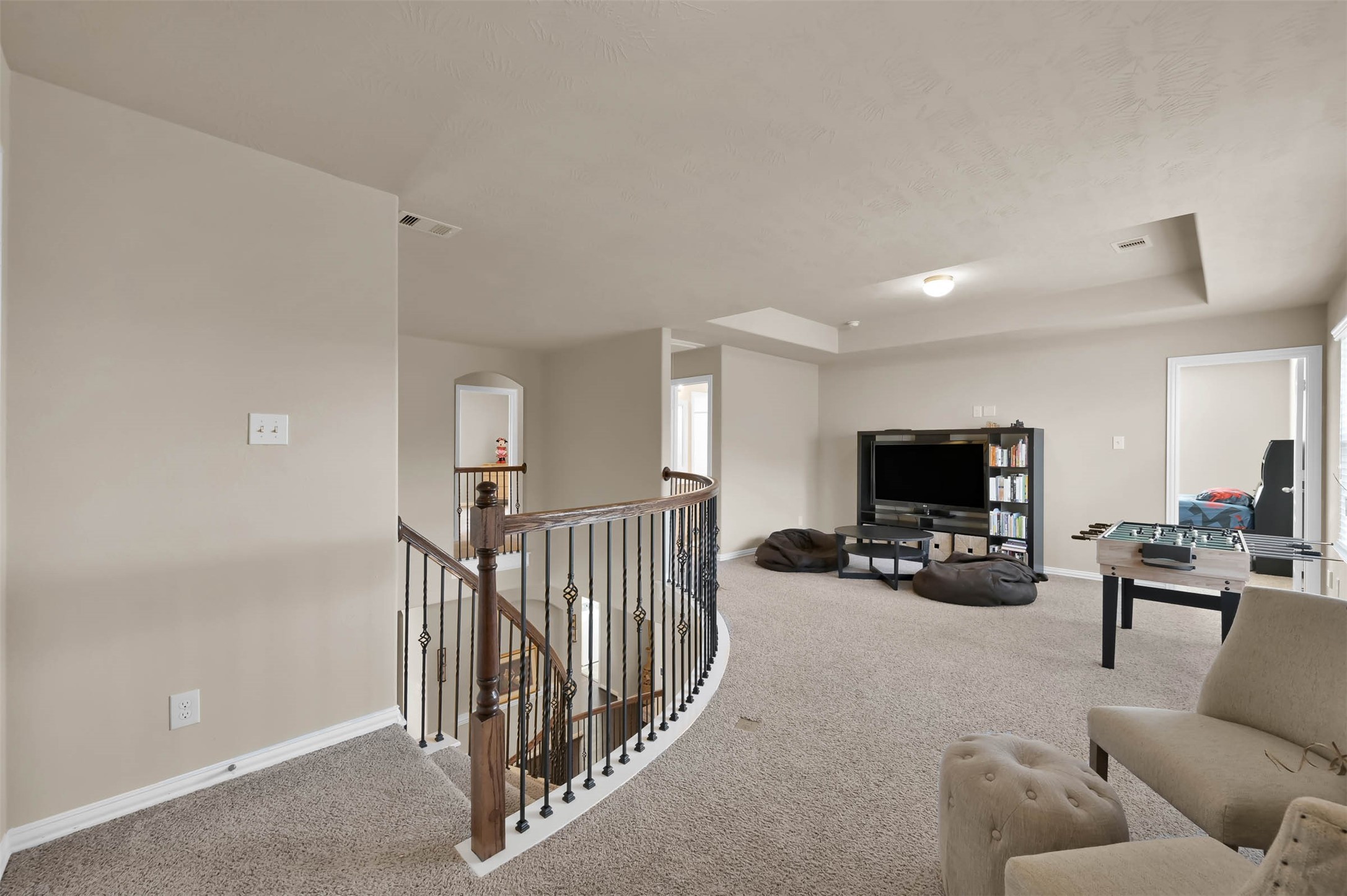 Atop the stairs is the open gameroom area central to the 3 bedrooms.