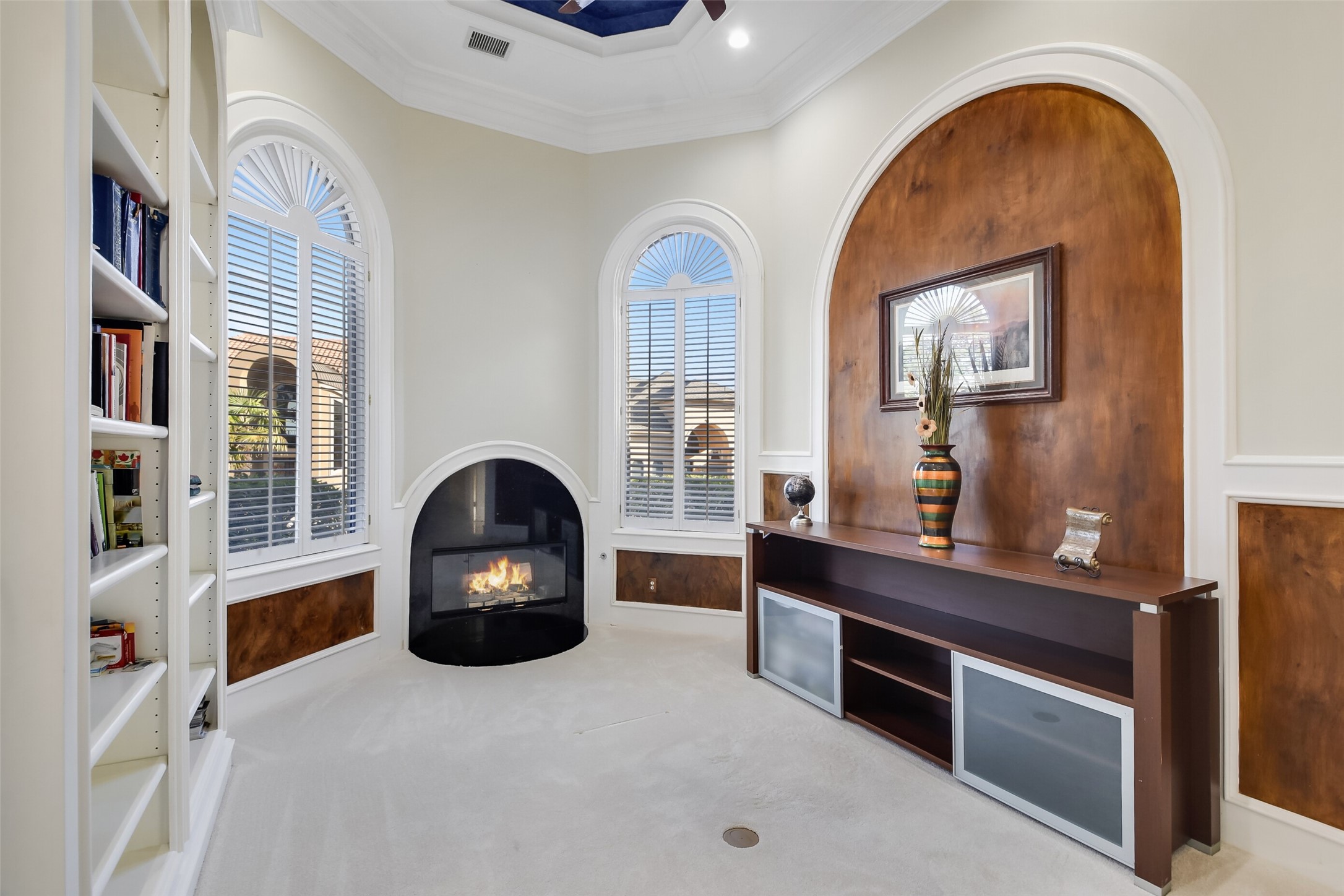 Study/Office with lakeview boasts built-in shelves and a gas log fireplace.