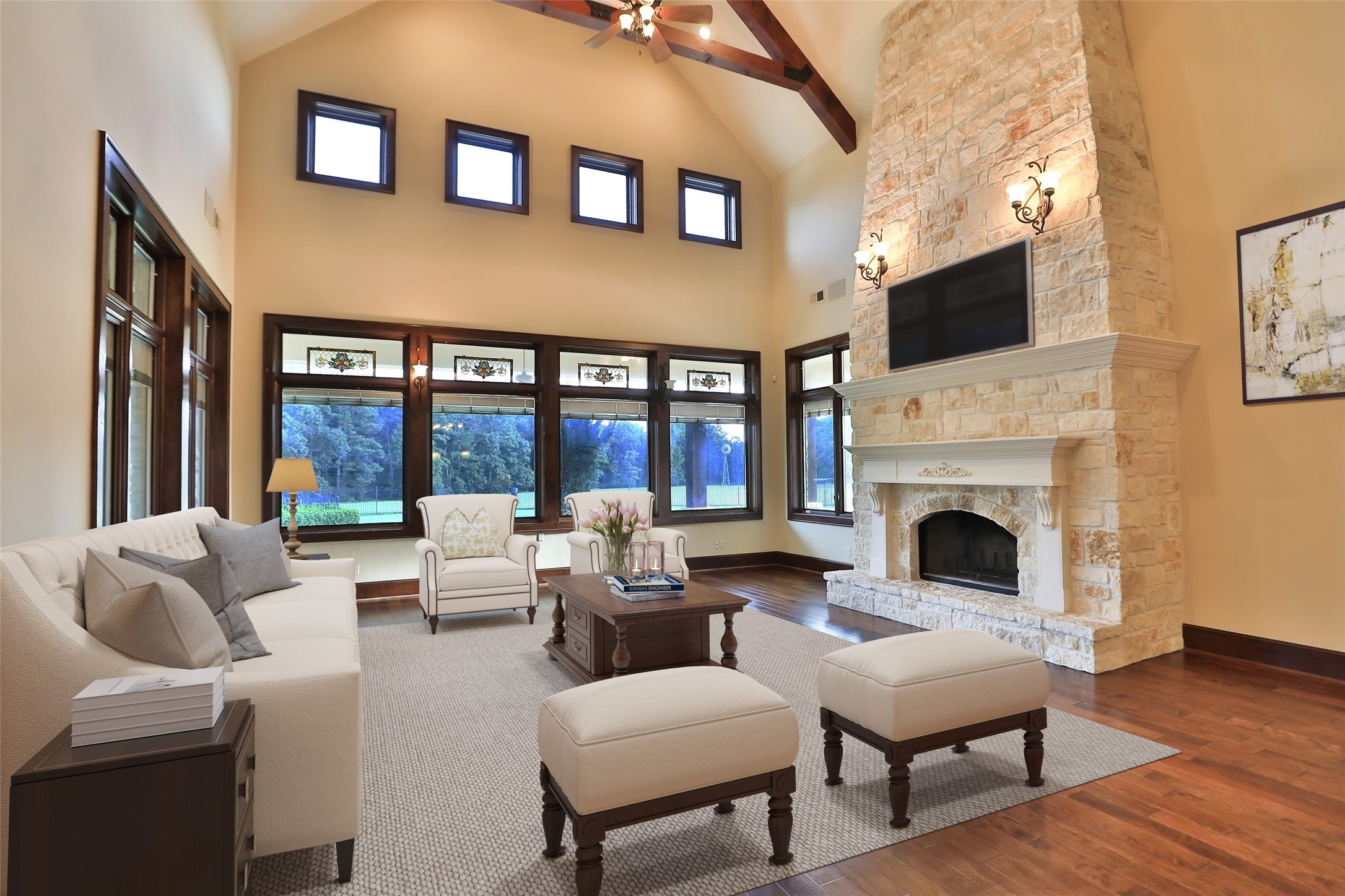 The gigantic family room features a wall of windows that overlook the amazing outdoors. Imagine looking out the window and seeing nothing but your land!