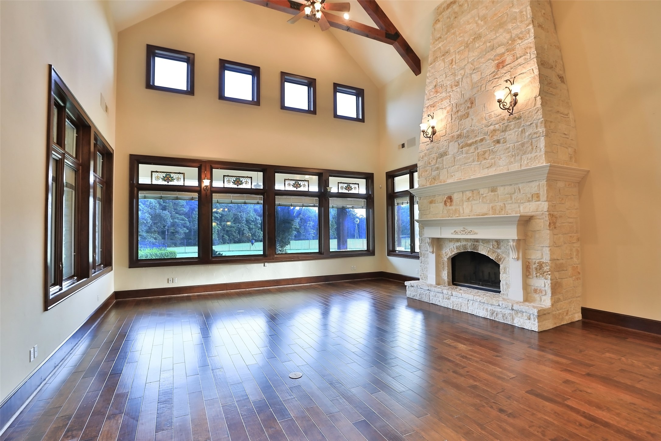 The soaring ceiling features outstanding wood beams. Large stone fireplace that is from floor to ceiling and will help keep you warm during the cold months. Pella windows throughout the house.
