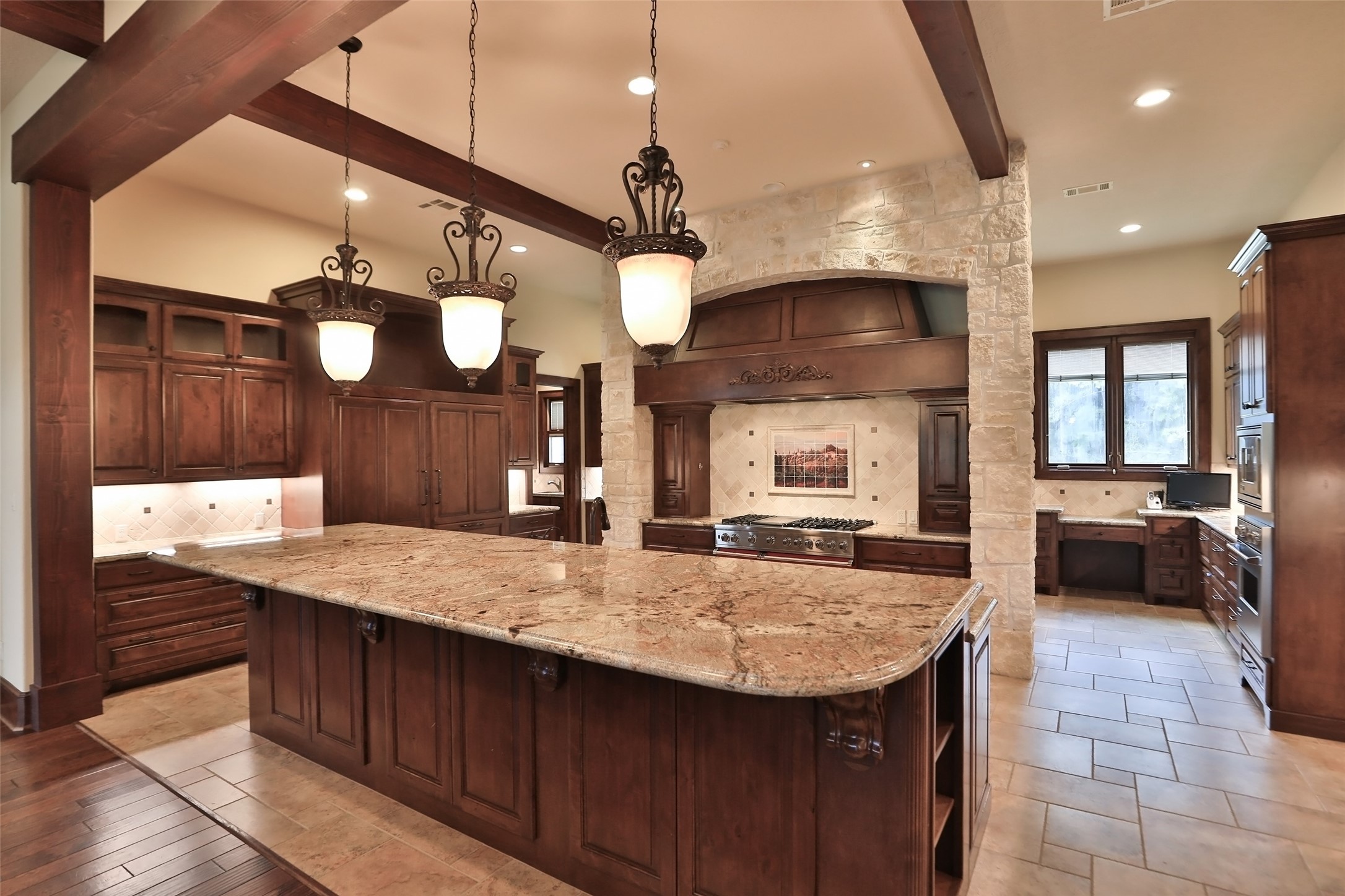 This gourmet kitchen will impress the Chef in the family. Spectacular granite counters, spacious breakfast bar, unique light fixtures tons of custom cabinets.