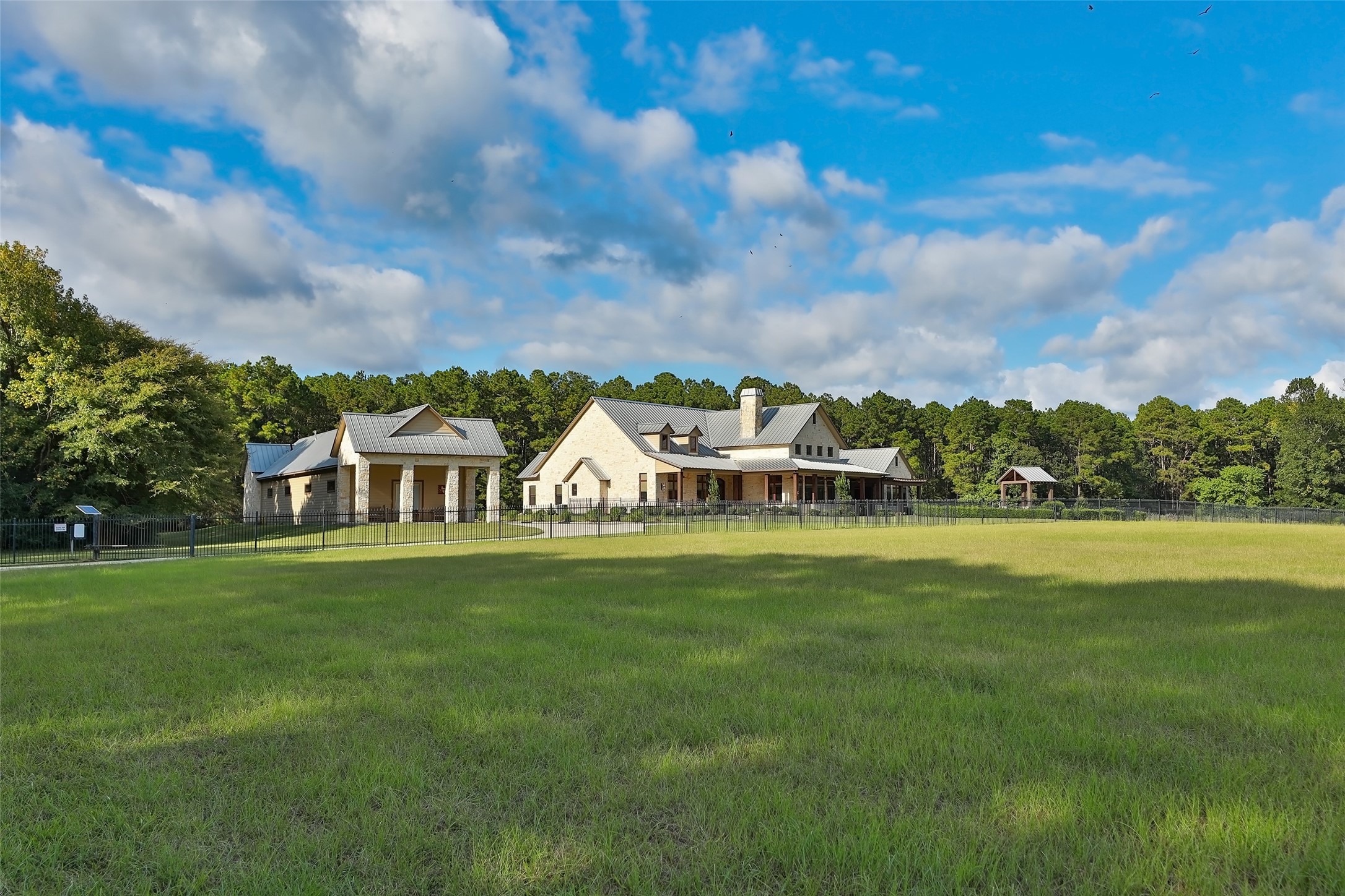 A view from the acreage to this stunning sprawling house.