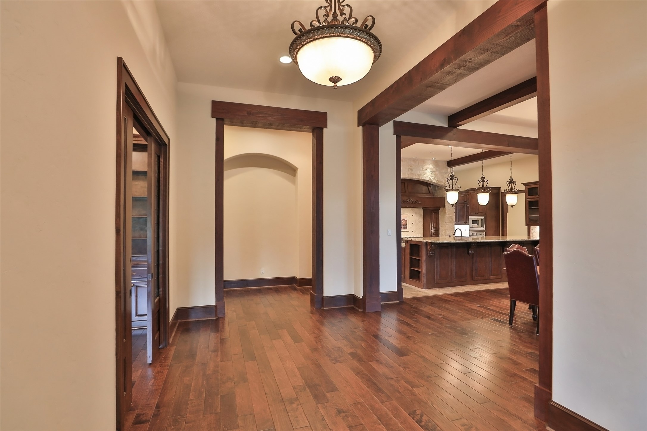 Enter the wide foyer to this home. You will see tremendous wood work and custom cabinets throughout the house. Beautiful door headers add a rustic style. Stunning hard wood floors throughout.