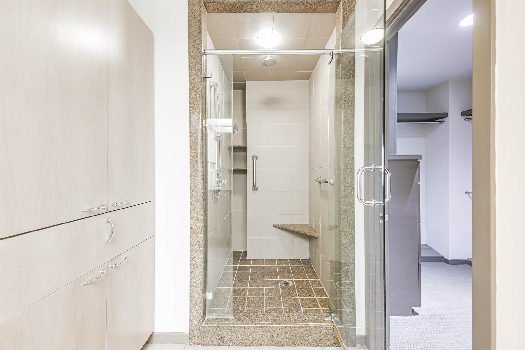 Ensuite primary bathroom has dual vanities, a soaking tub, separate glass-enclosed shower, and two walk-in closets.