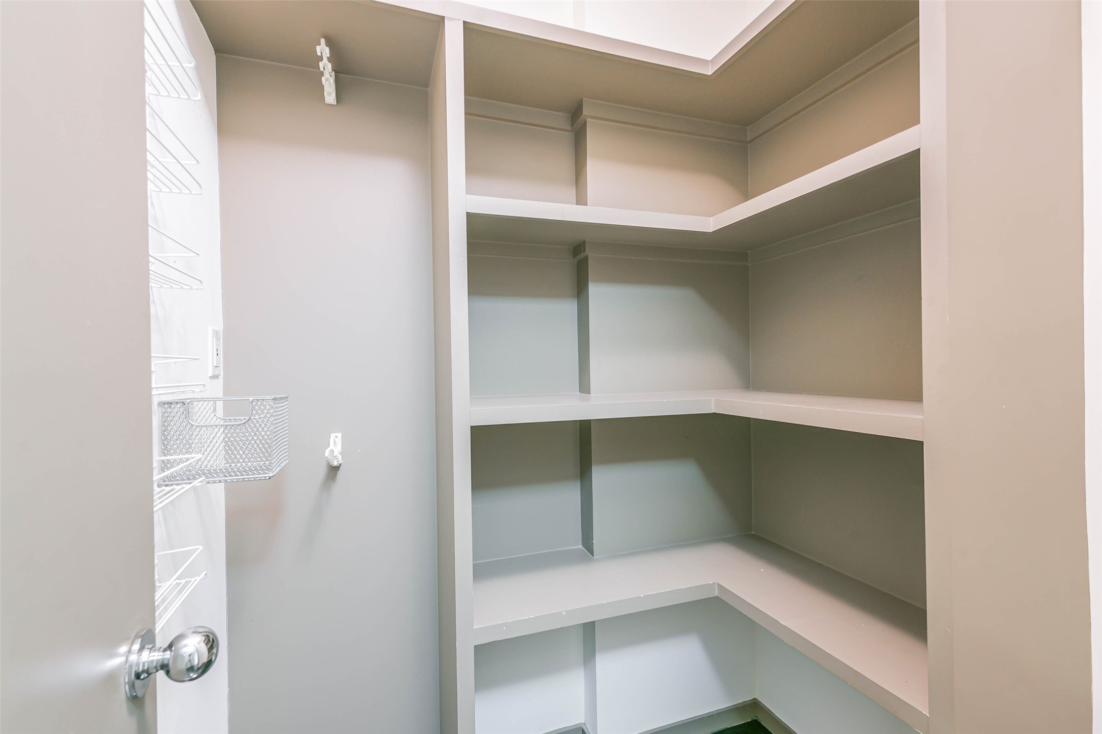 Rare walk-in pantry with custom shelves making it easy to keep organized.