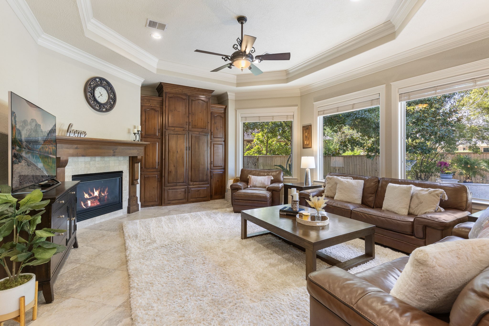 The family room allows for the main gathering space with floor to ceiling custom built in cabinetry for your storage and media needs, embellished millwork and a gas log fireplace with tile surround and wood mantle.