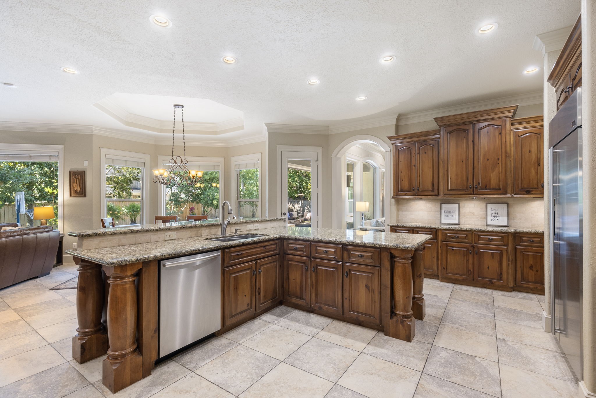 The kitchen offers an intricate center island that features additional seating, dishwasher and double under the counter mounted sink.