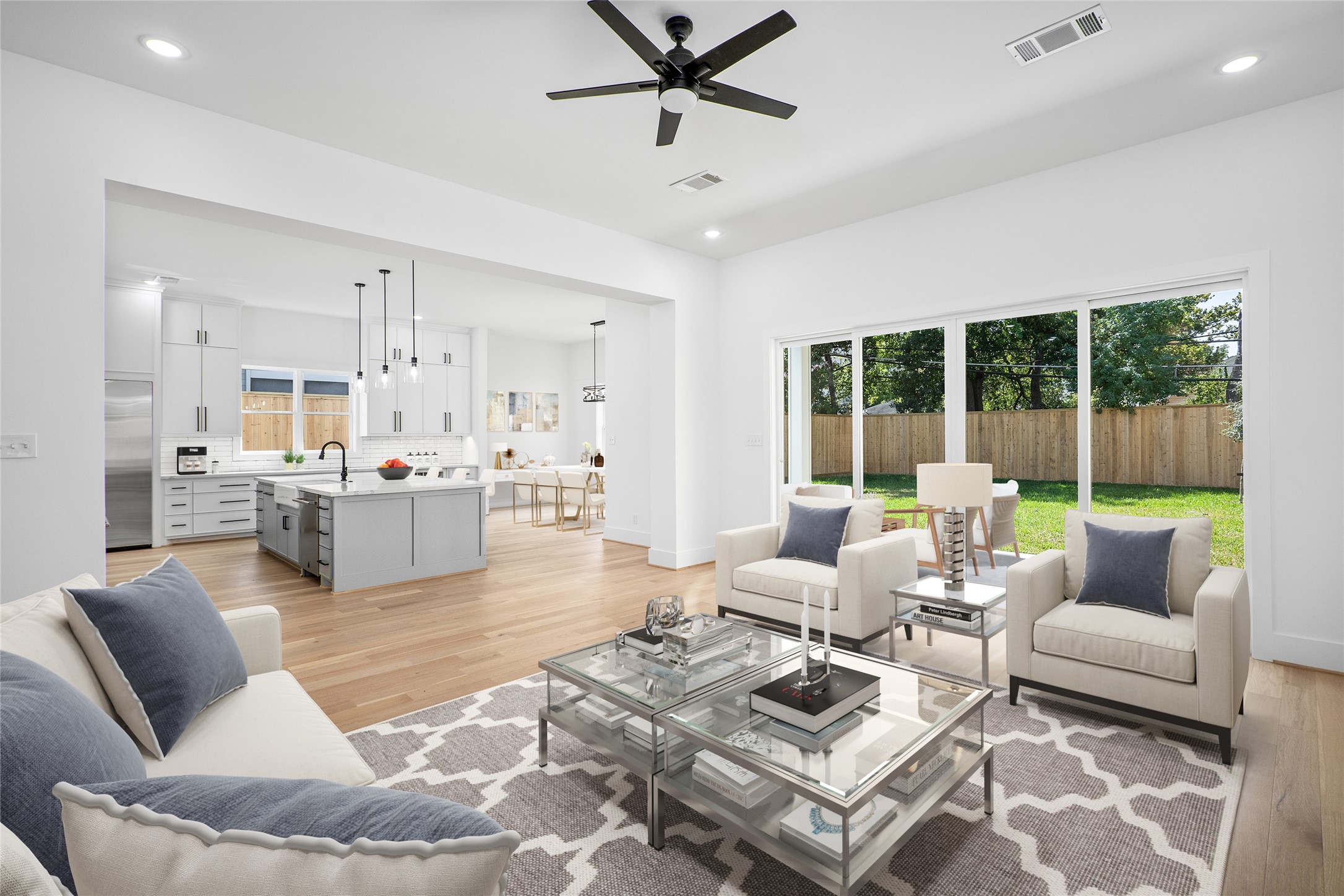 Here is a look from the living room towards the kitchen and dining areas, showing you the open concept home. Let's take a step through the sliding glass doors to the backyard. *Virtual staging has been added*