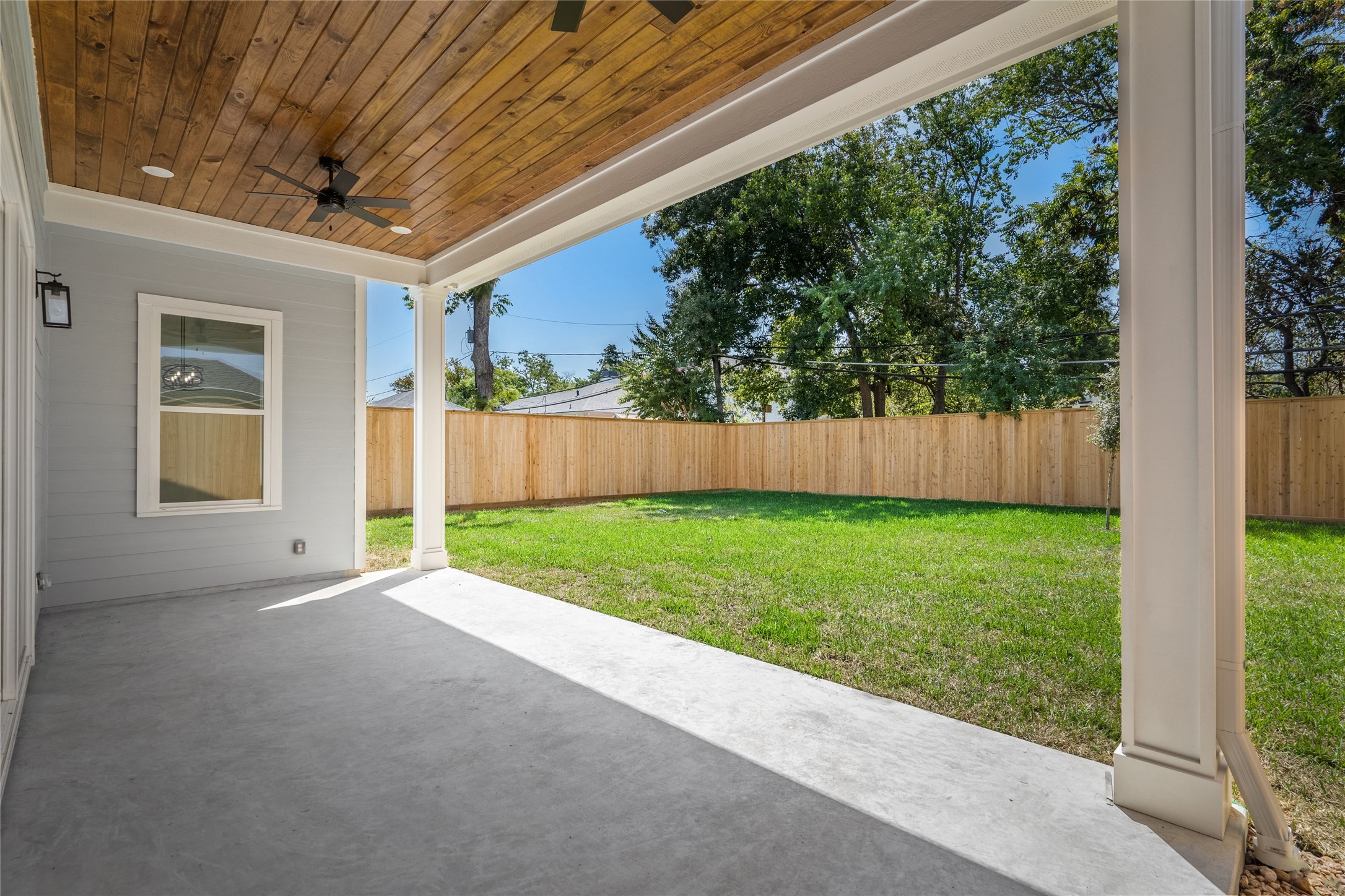 The large covered patio is spacious enough for outdoor furniture and is pre-plumbed for water and a gas line (just out of frame on the right). The expansive yard is a real differentiator with this home!
