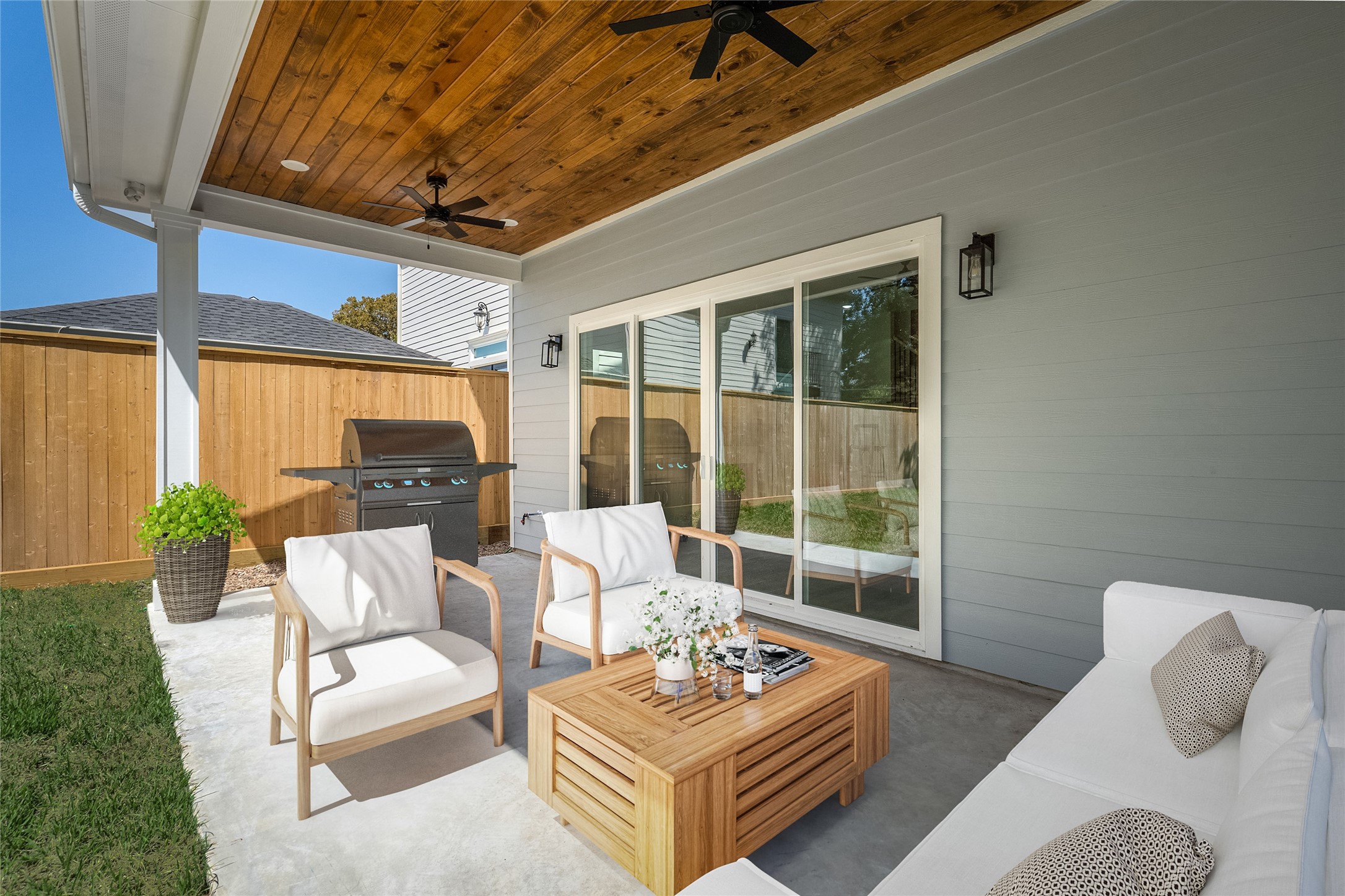 The covered patio sits beneath two ceiling fans and is perfect for relaxing on those cool fall evenings. The virtually staged grill sits where the water/gas lines are located. *Virtual staging has been added*