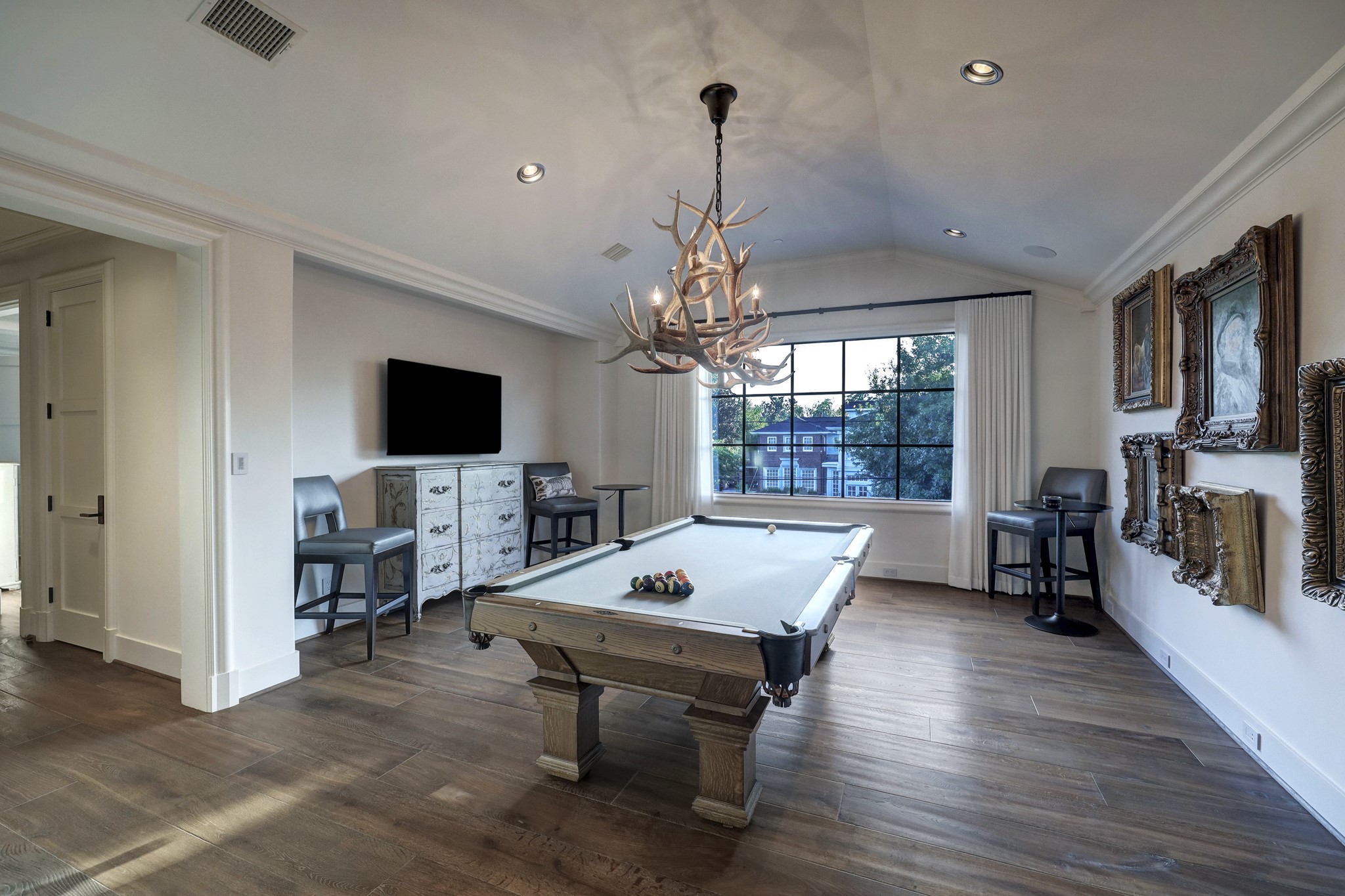 The second floor game room (20 x 15) has 11 foot vaulted ceilings and an impressive Antler chandelier.