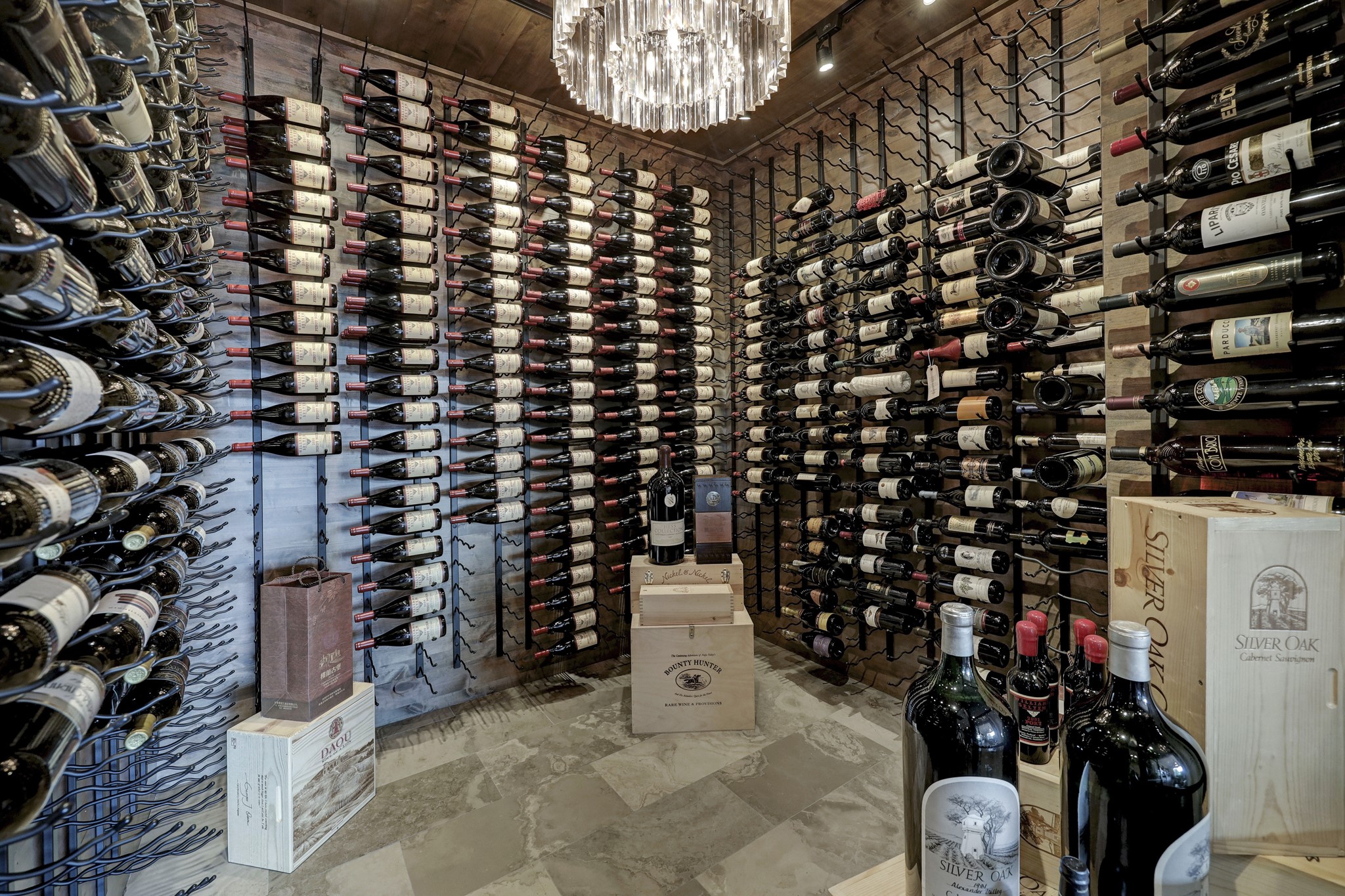 In the insulation wine cellar (8 x 7), wall-to-ceiling wine racks hold up to 750 bottles. Travertine marble floors and French oak wood on both the walls and the ceilings provide a luxurious feel to the room.