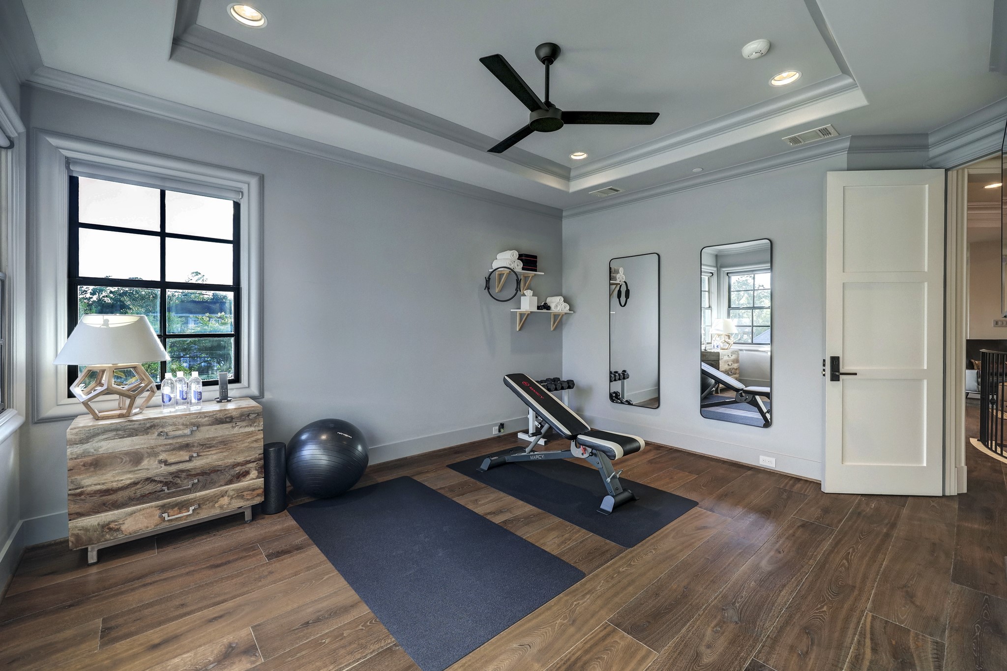 Currently used as a gym, this room has tall 10 foot tray ceilings and includes an en-suite bathroom.
