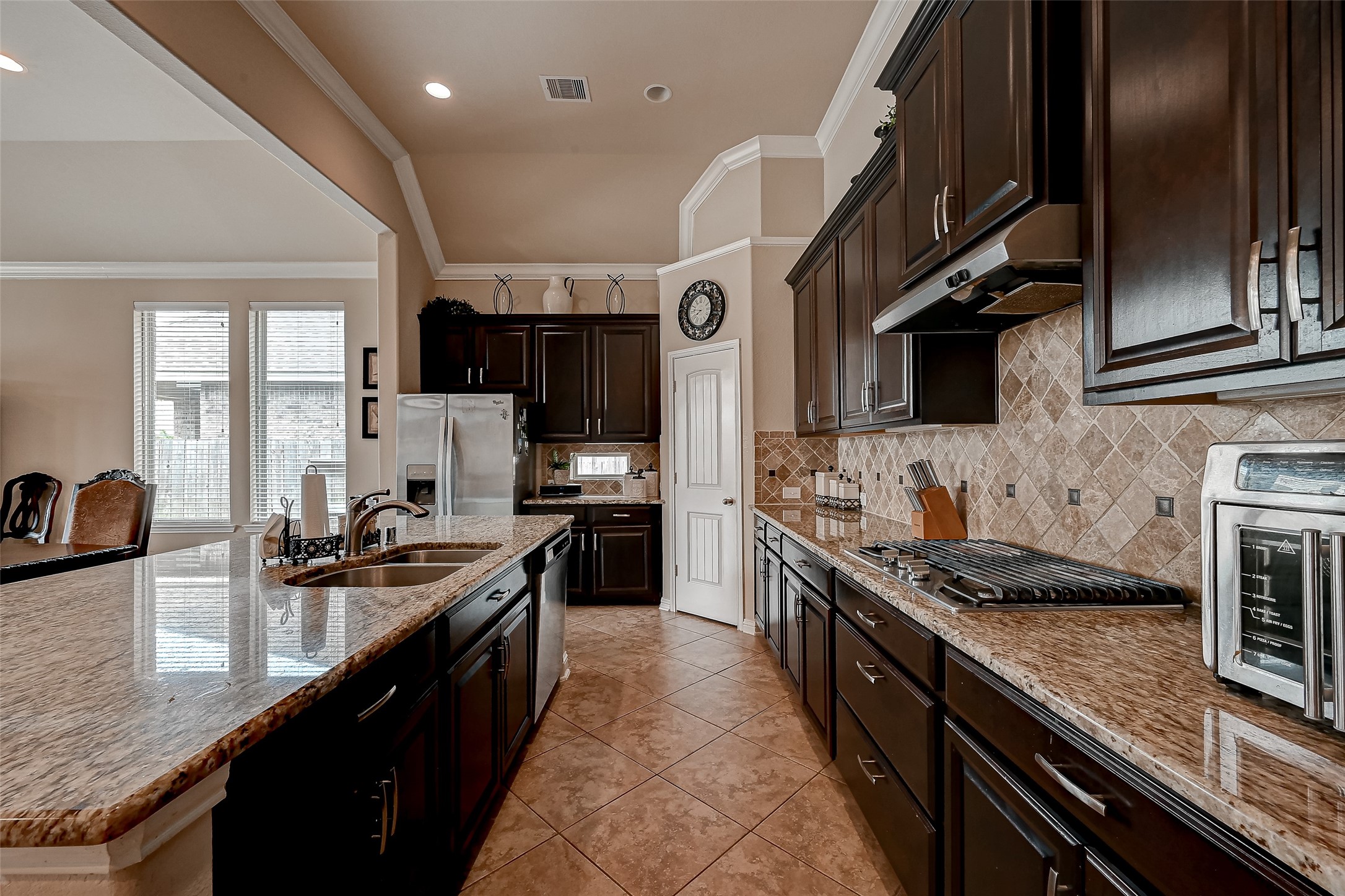 The heart of the home features a gourmet kitchen with top-of-the-line stainless steel appliances, ample storage, and an expansive center island. It's a culinary enthusiast's dream come true.