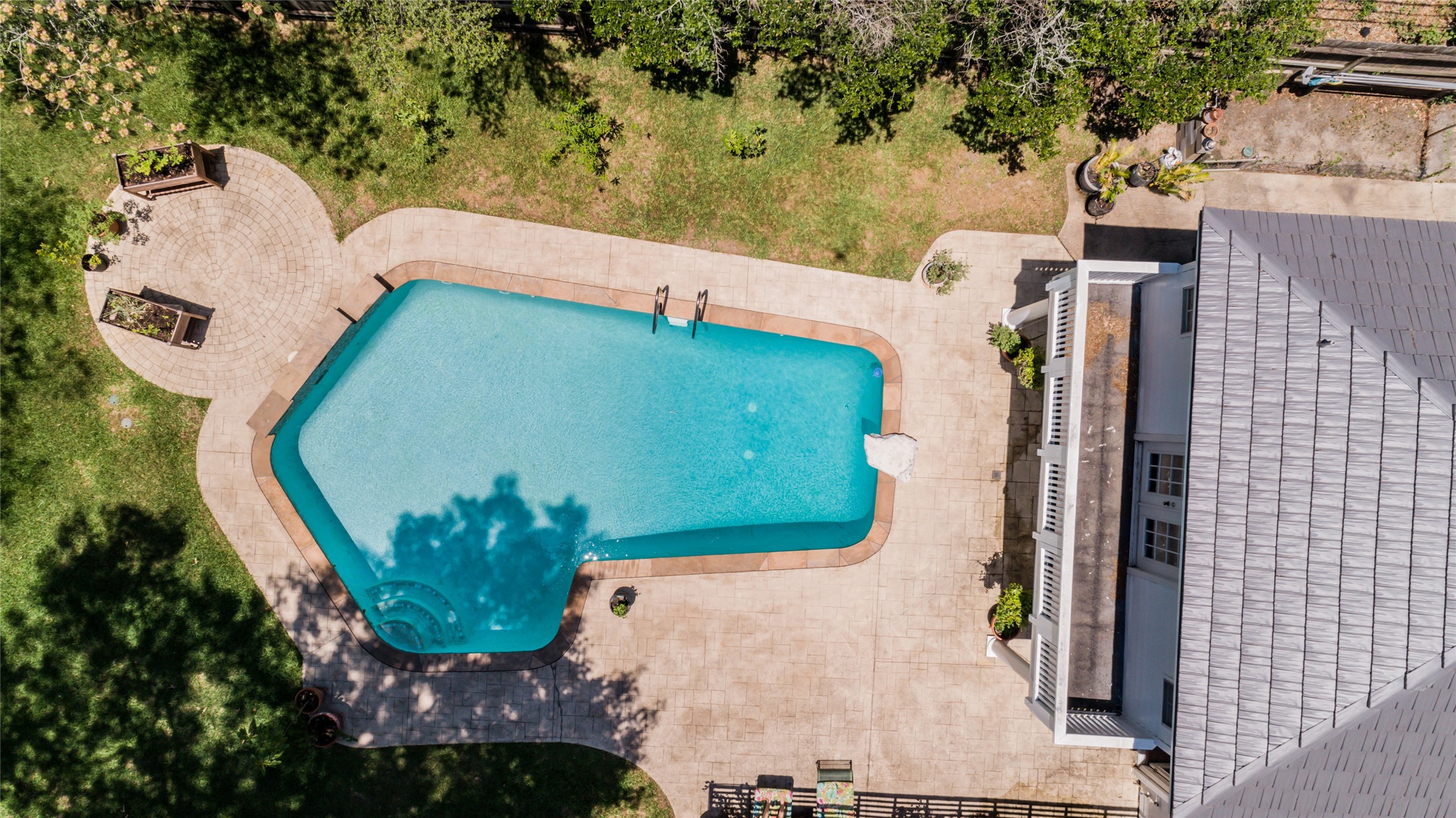 Aerial shot of the pool and backyard.
