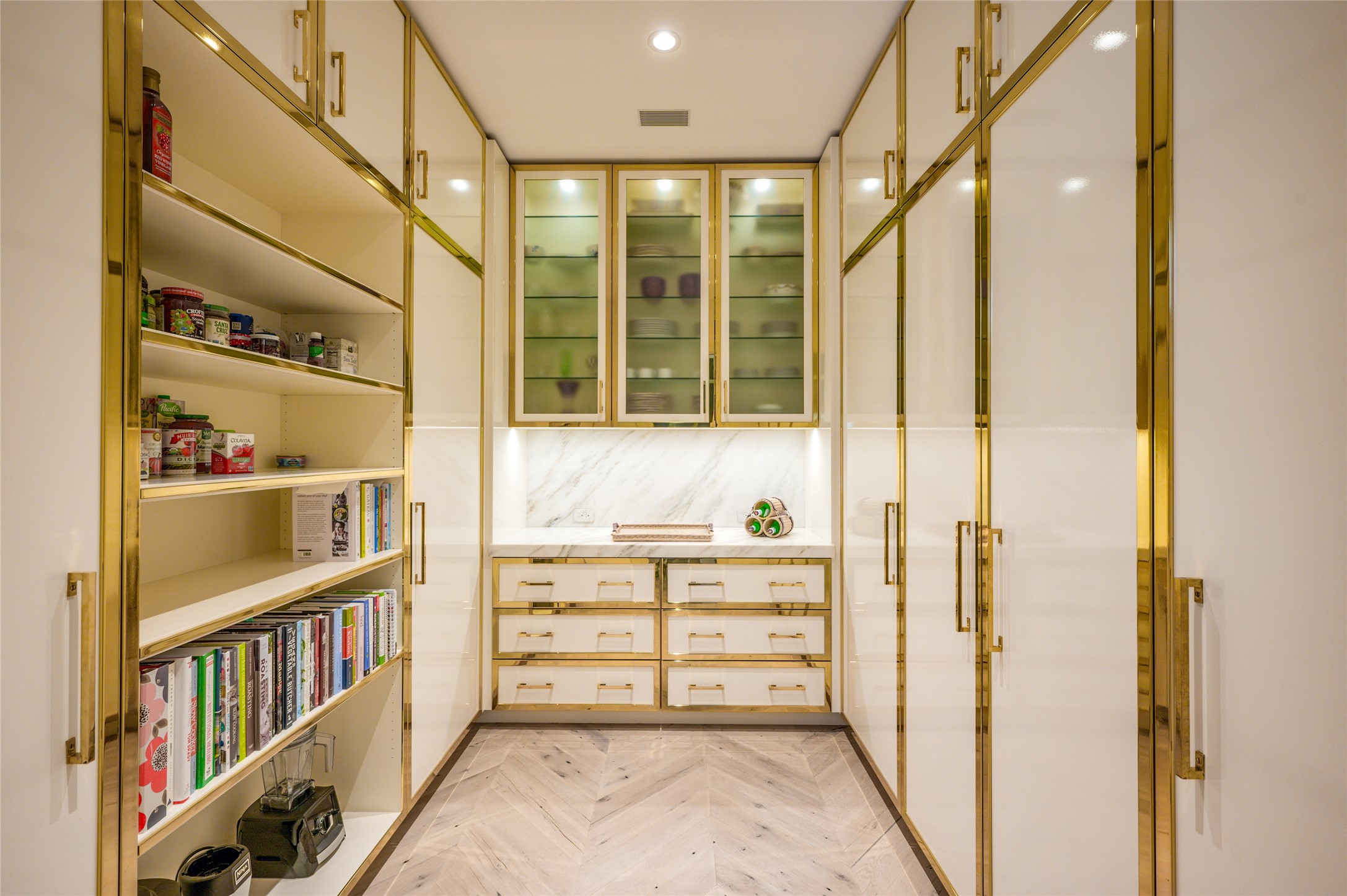 Stunning coordinating pantry with abundance of cabinetry and Subzero freezer.