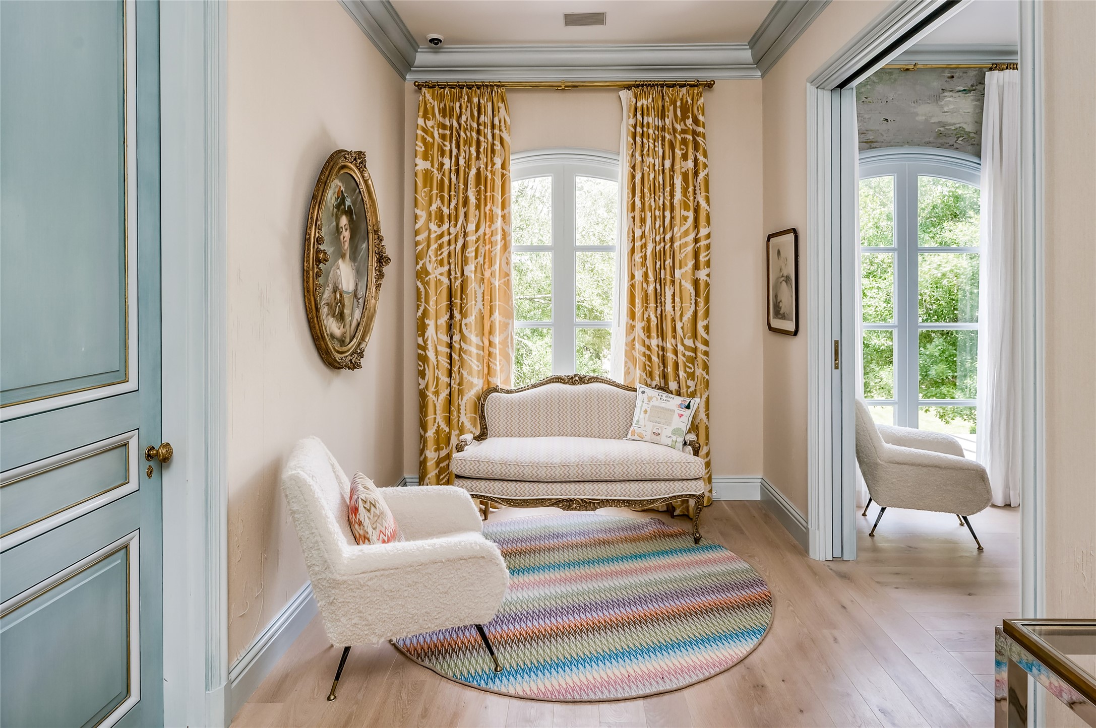 Cozy second level landing space with textured wallpaper and beautiful hardwoods.