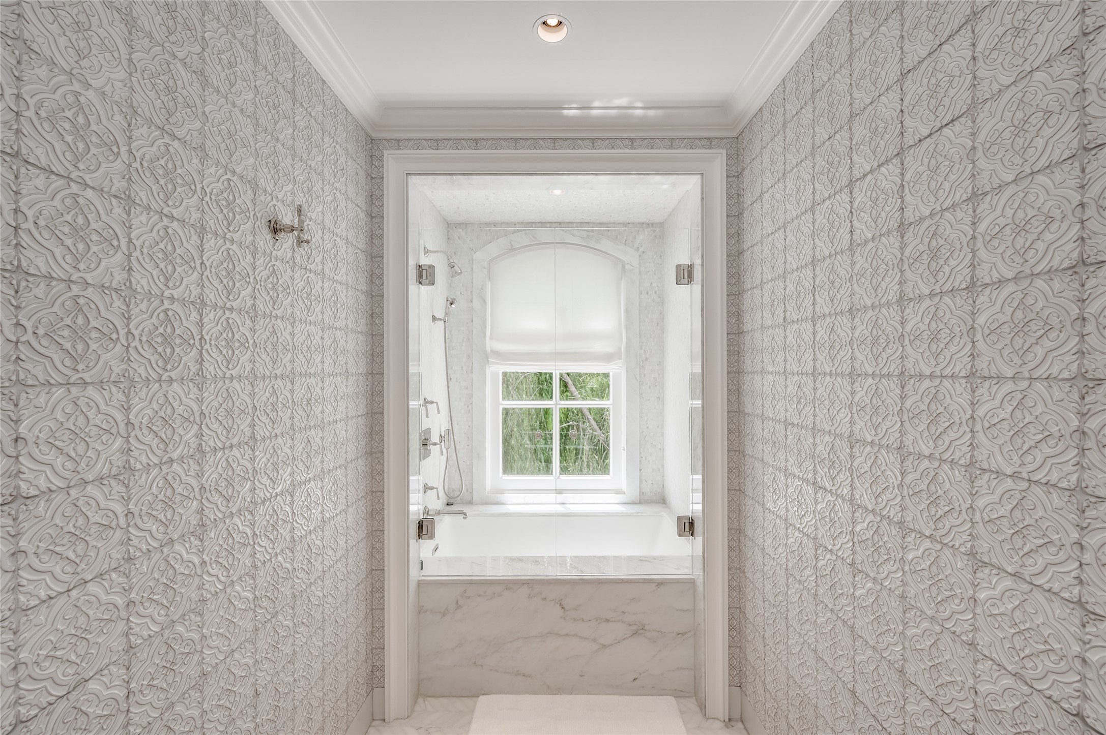 Guest baths are certain to impress with floor to ceiling ceramic wall tiles serving as entry to a beautiful bath.