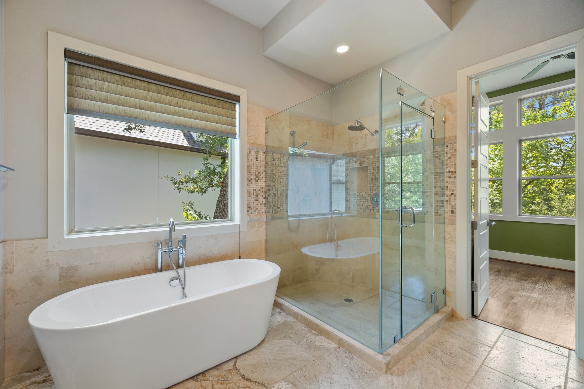 Stone flooring and accents abound in the primary bath areas, expansive custom walk in shower.