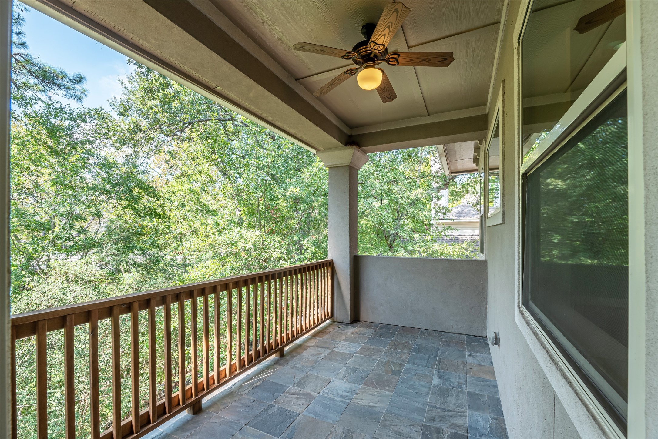 Primary suite balcony overlooking ravine areas and lush trees
