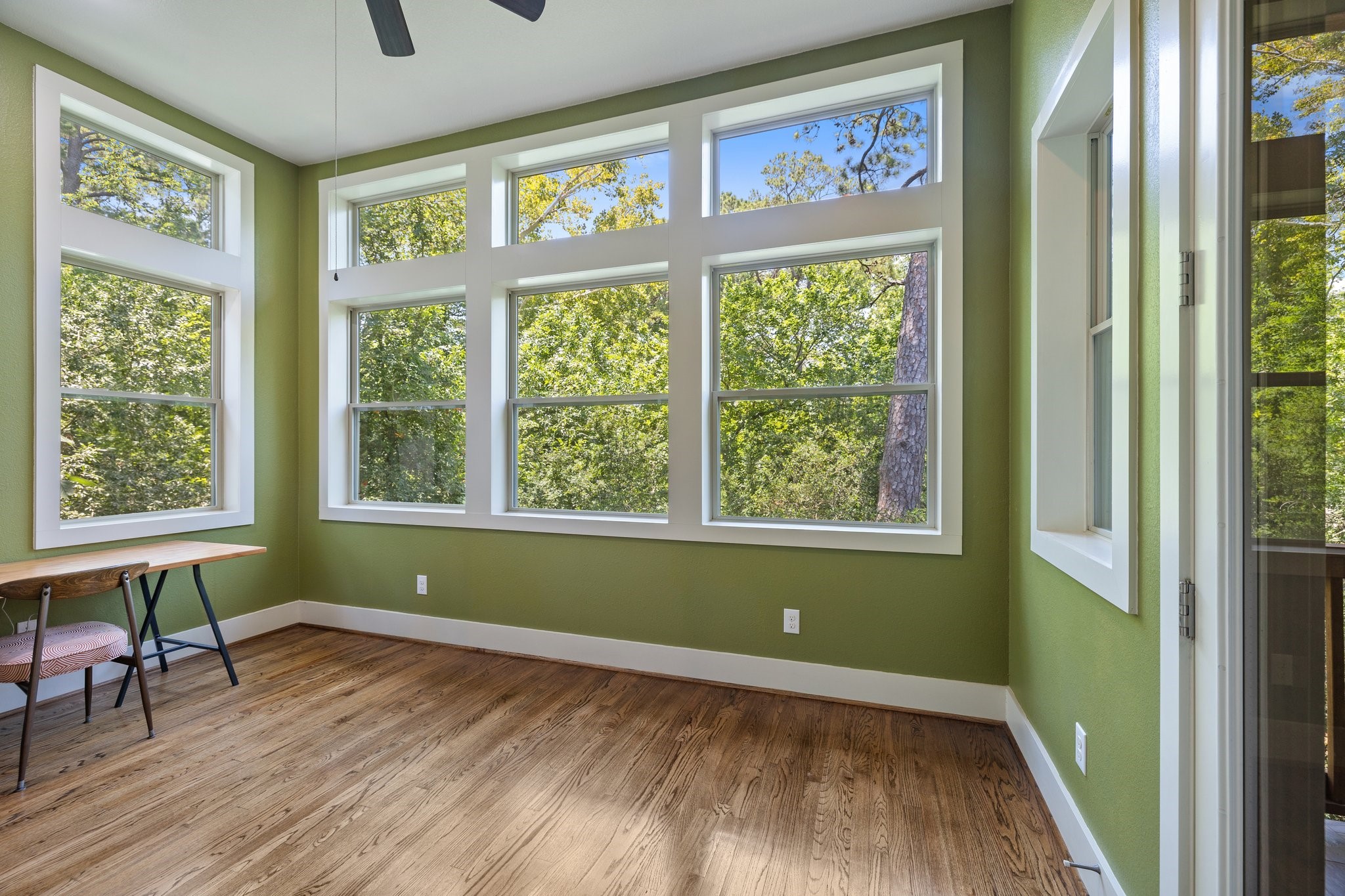 Adjacent to the primary suite, a private large sitting/flex room would make the ideal yoga, art or crafting space. Massive wrap around windows offer amazing views.