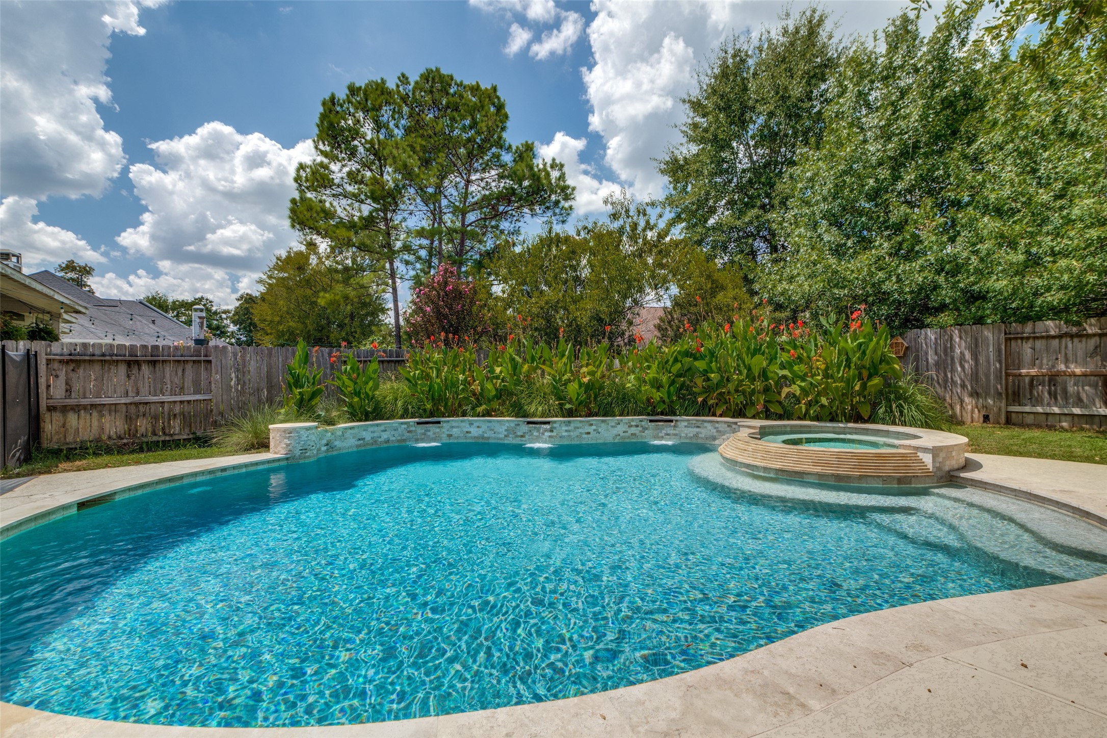 Lush landscaping is a great backdrop to the pool.