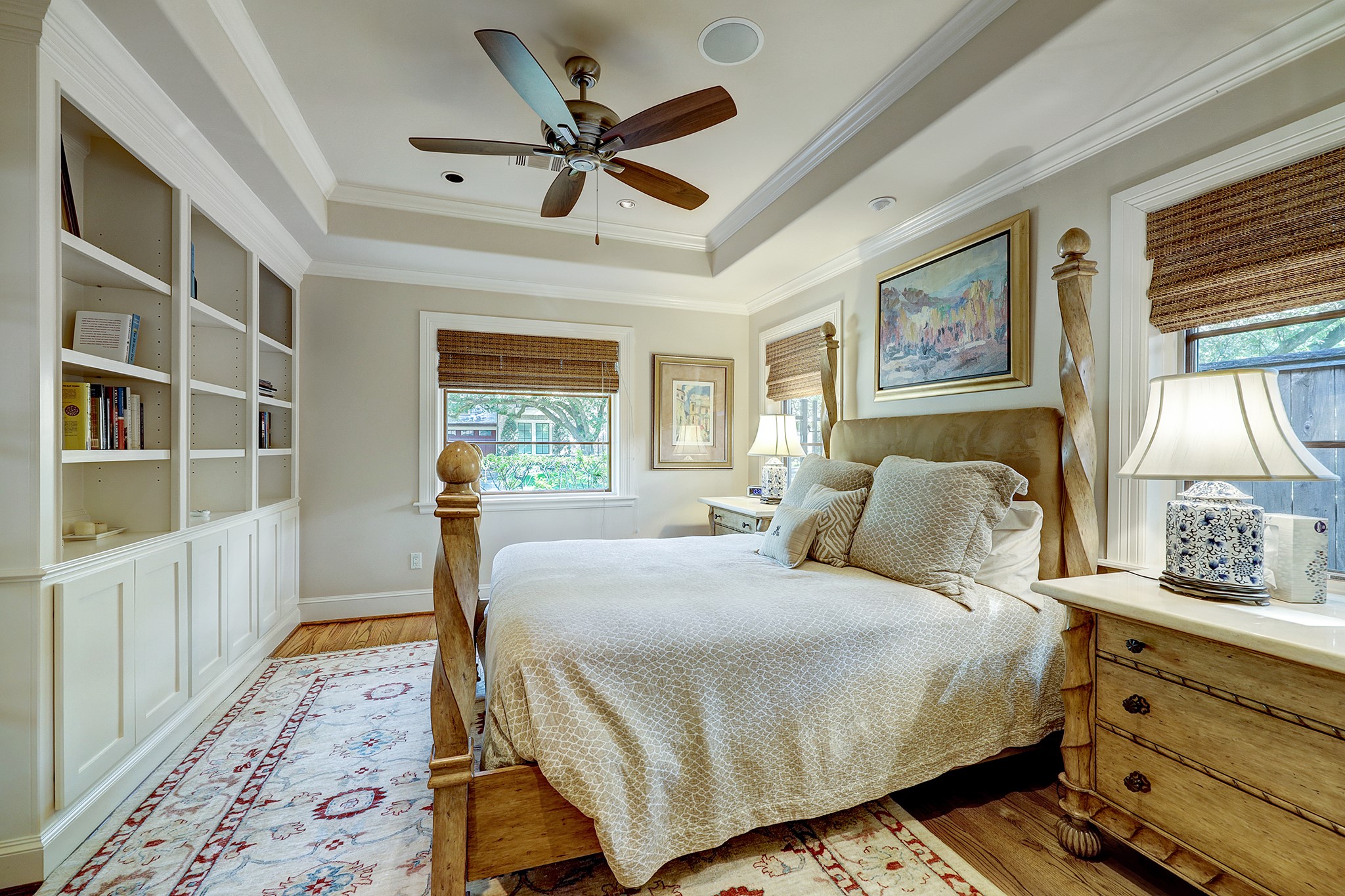 Secondary bedroom with tray ceiling, custom built-ins, and nice size closet.