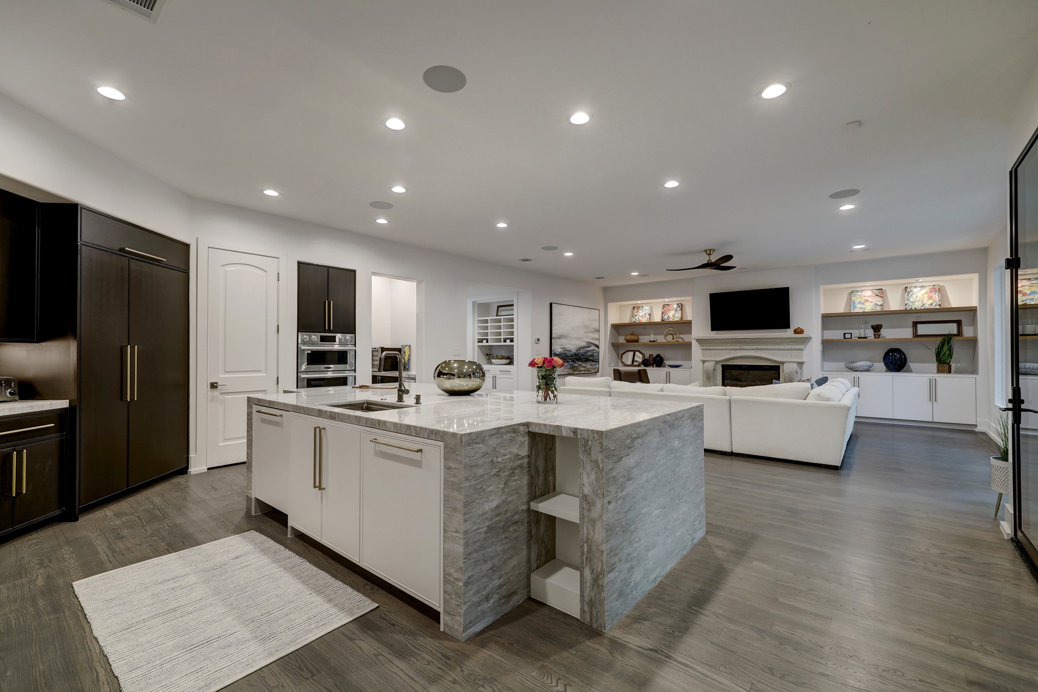 Totally reconfigured kitchen with custom, high end cabinetry with built in refrigerator opens to the den and over looks the tranquil backyard.