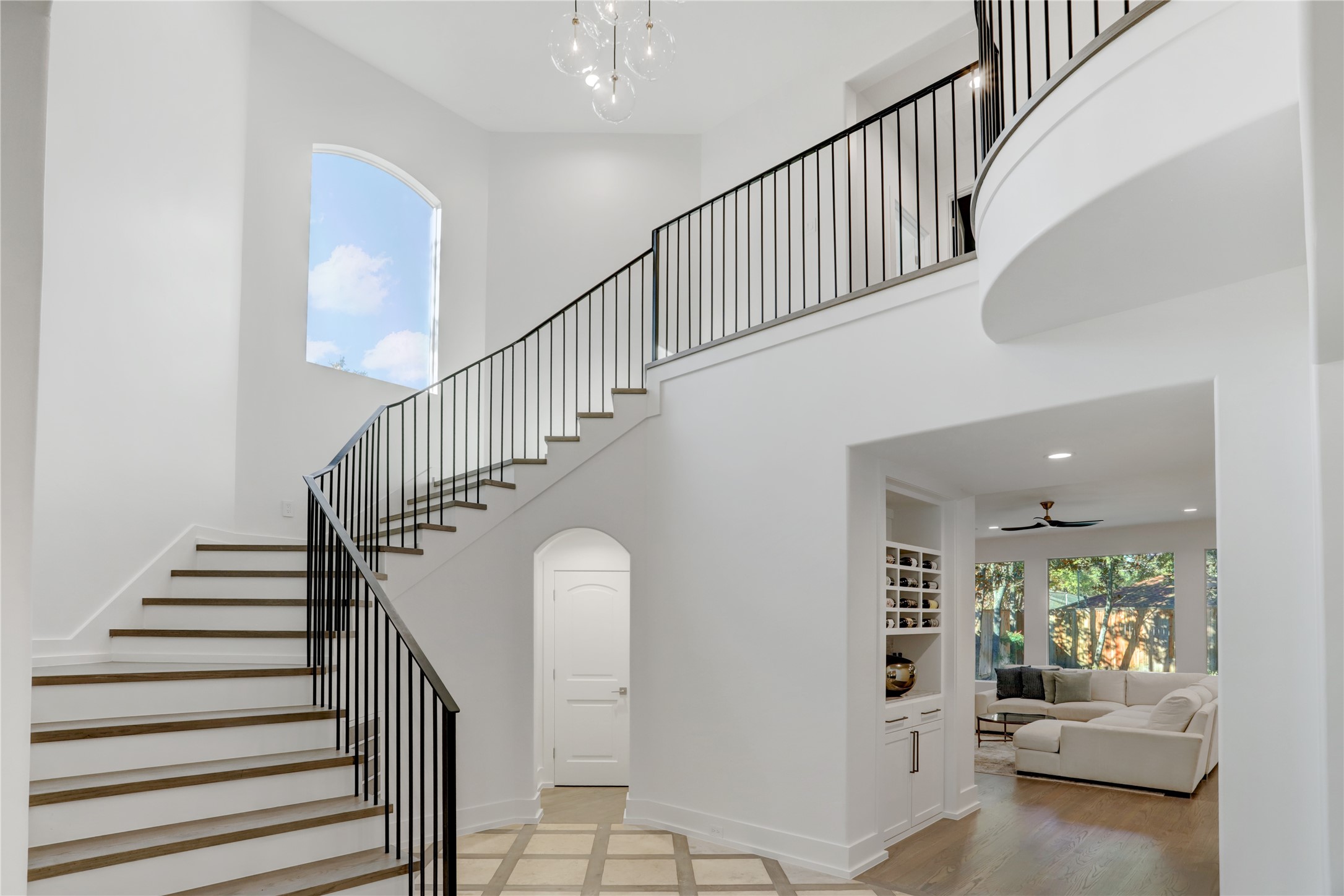 Front, main staircase features custom contemporary handrails.