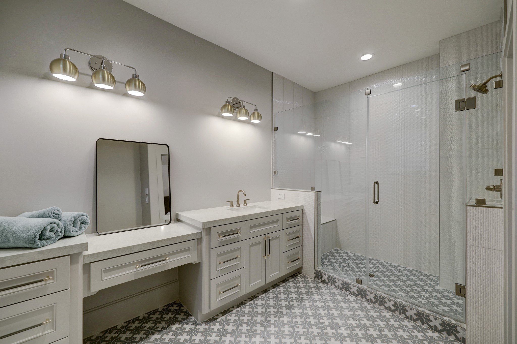 Spacious Ensuite bath with generous shower, cabinetry and counter tops. Gorgeous light fixtures and hardware.