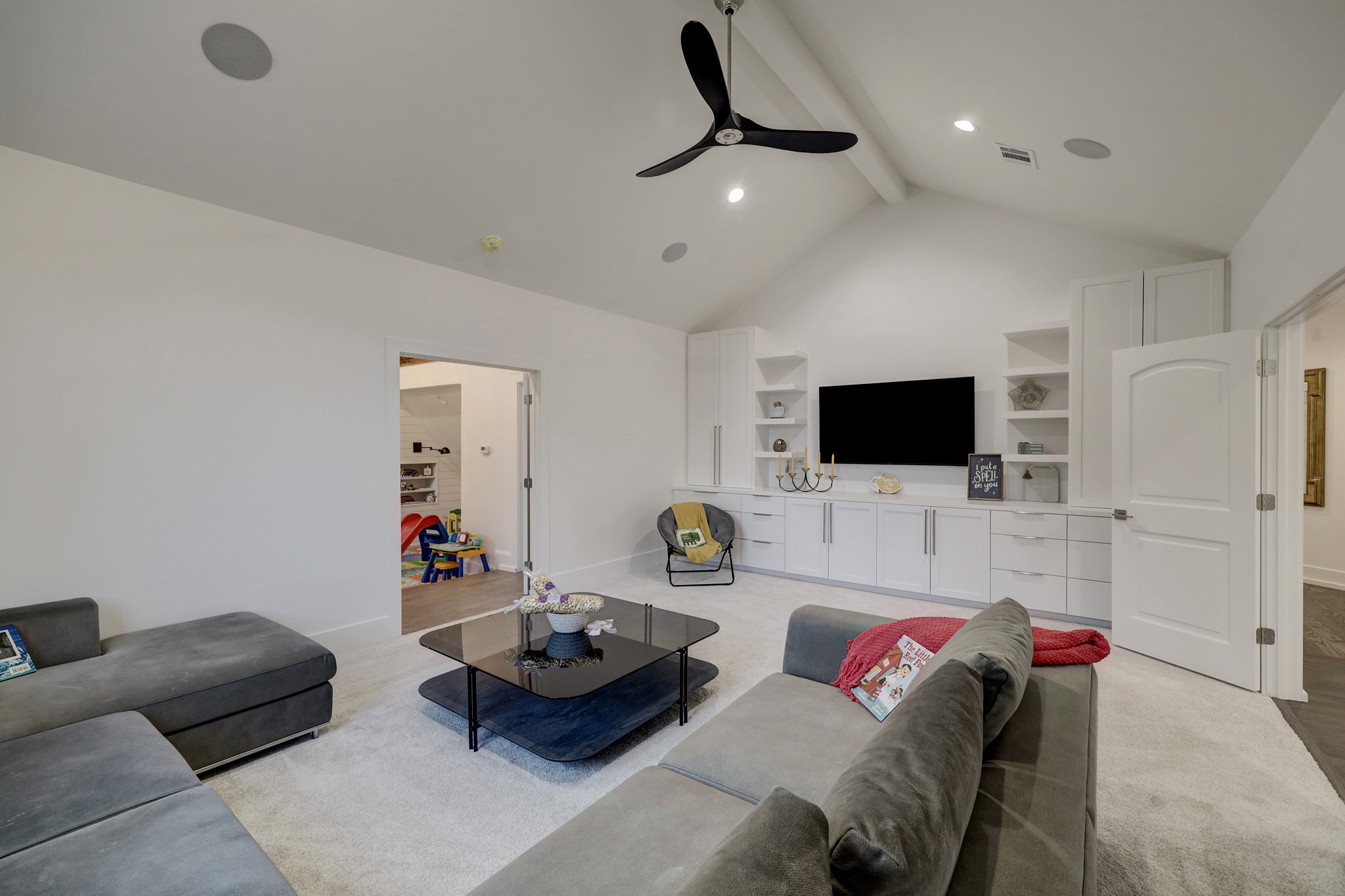 Fantastic game room for quality family time features plenty of built ins for games and more.