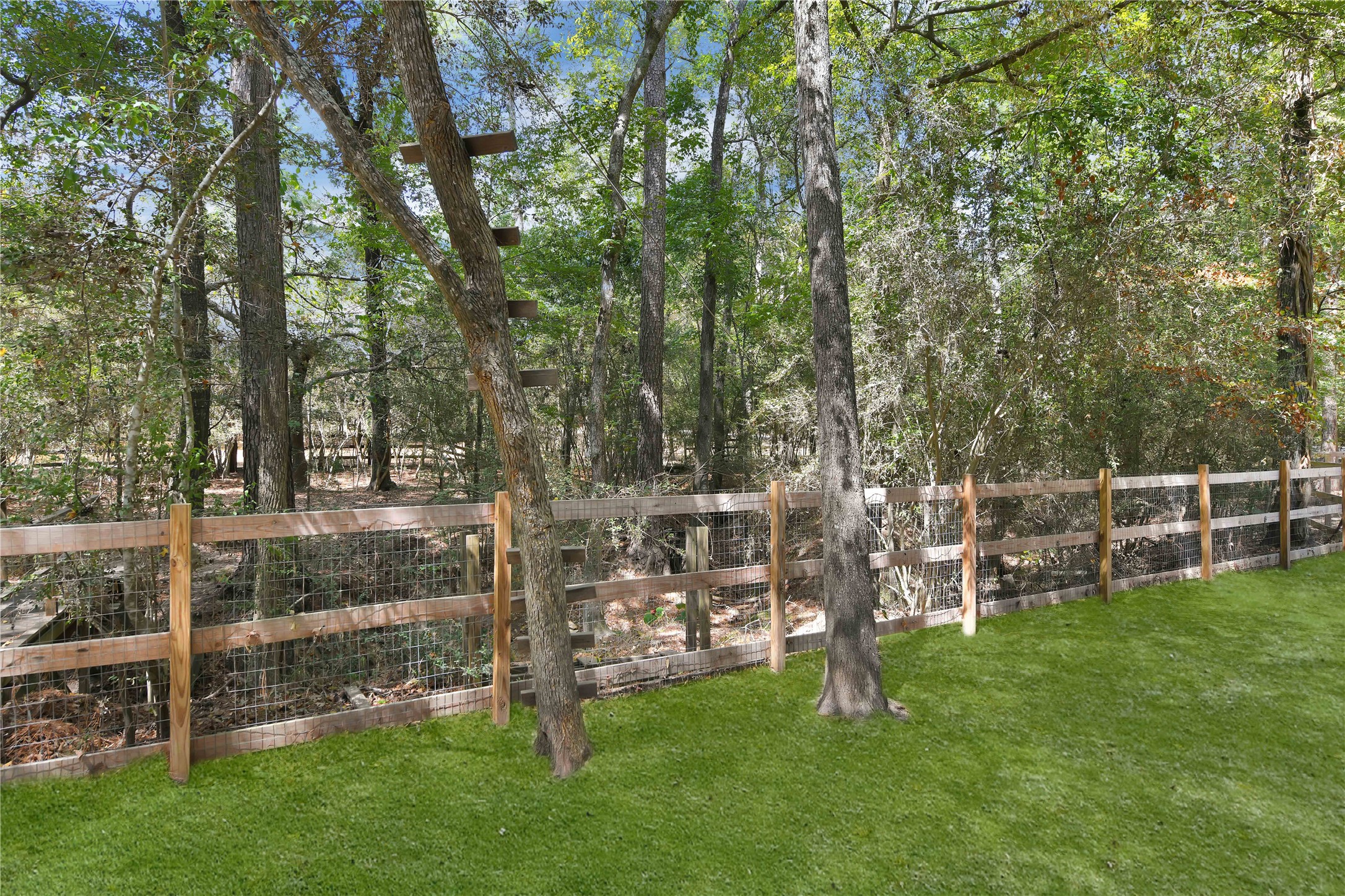 16603 Surrey Ln- Lovely fencing surrounds the property, sprinkler system, and gated entry.