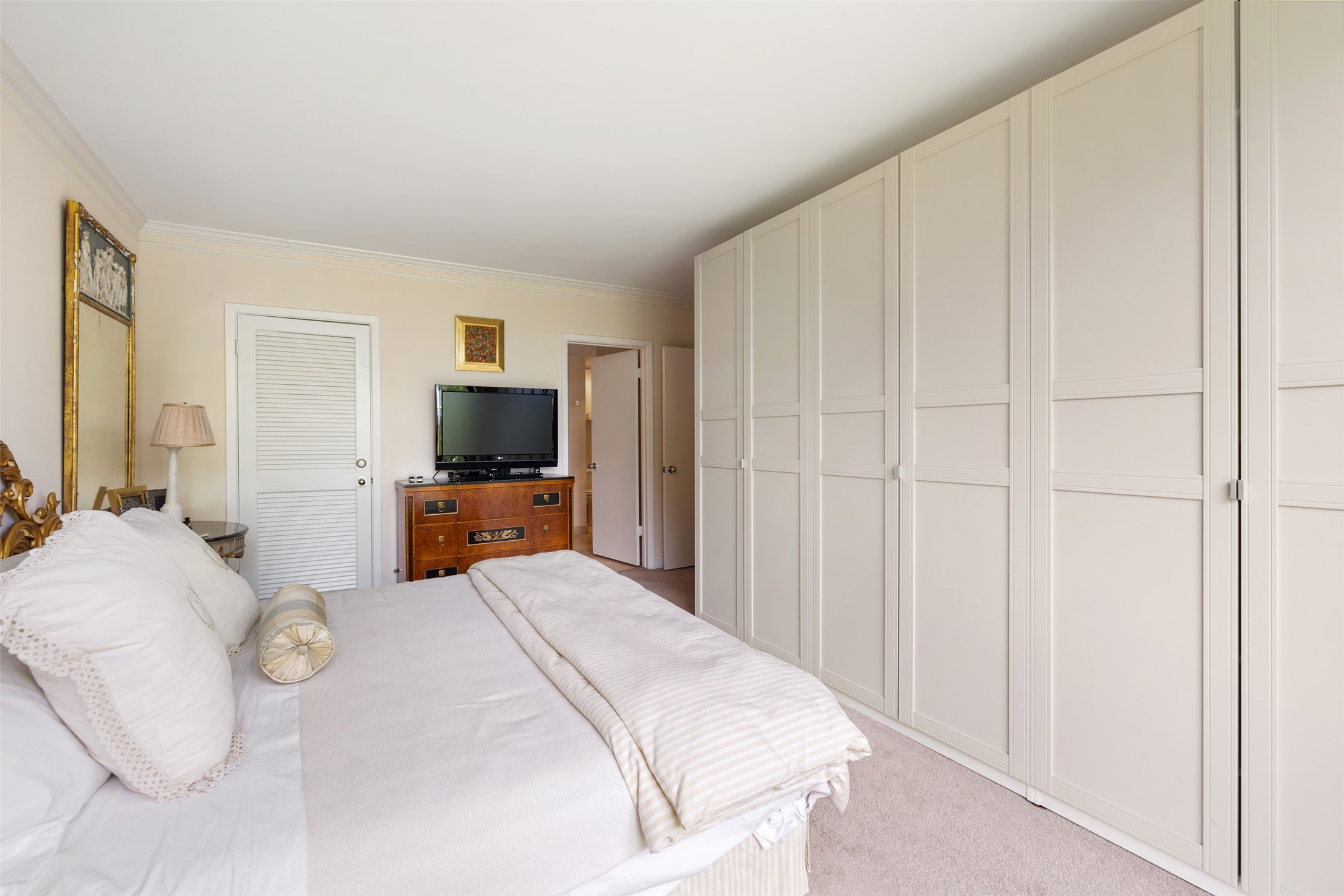 The primary bedroom has a plenty of room for extensive built in closet and storage system, as well as a separate walk-in closet.