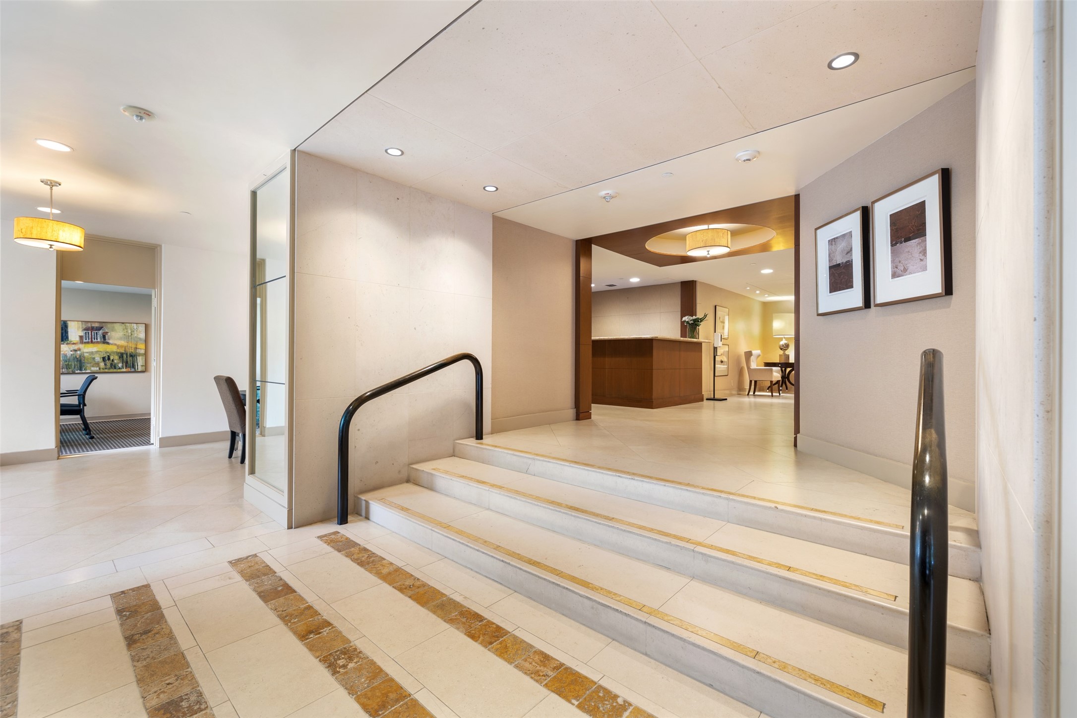 Stairs lead from the entry to the concierge desk and elevators