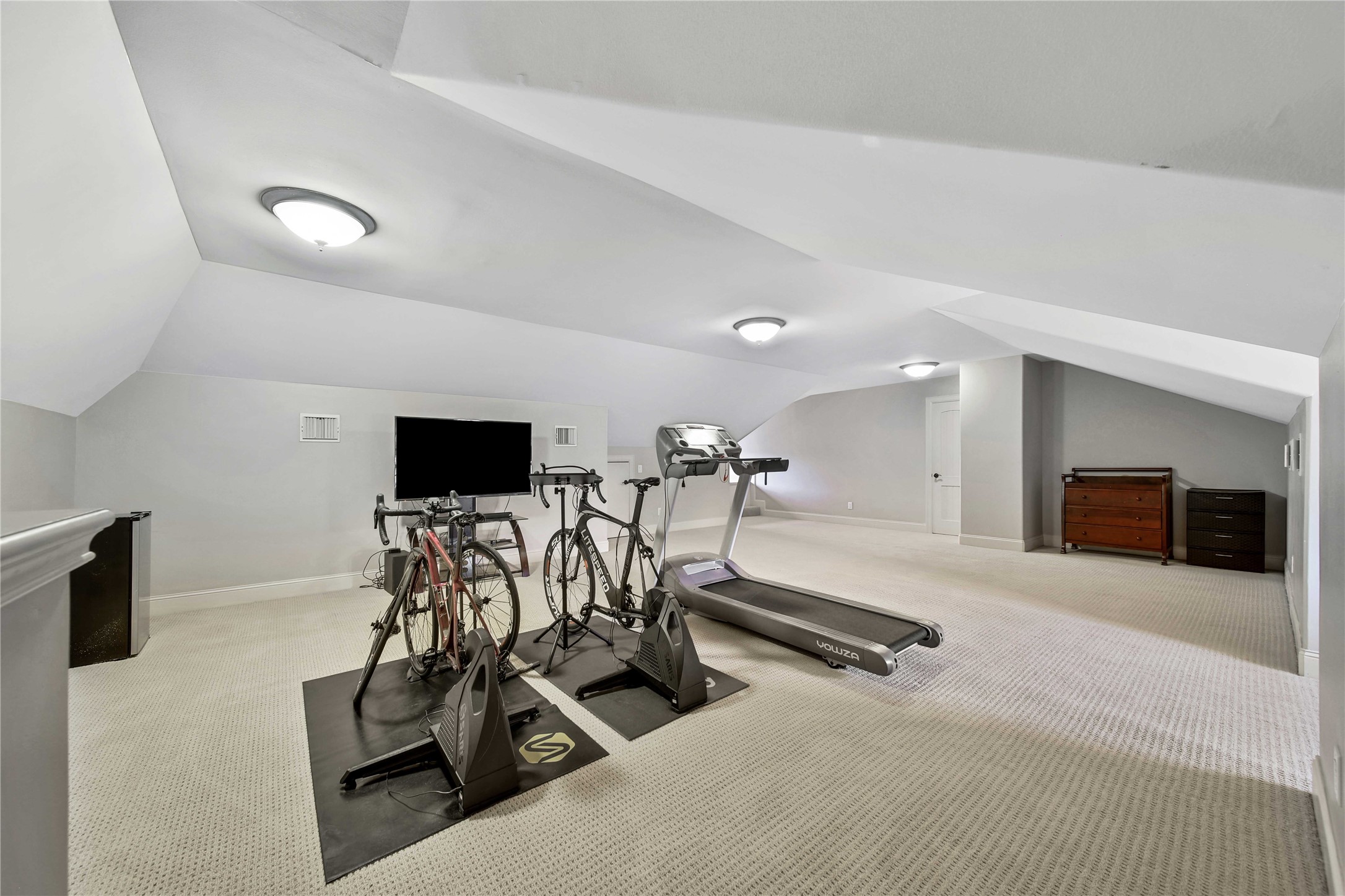 Last but not least, having a dedicated workout room offers several benefits. Firstly, it eliminates the need to travel to a gym, saving time and expenses associated with memberships or commuting. It also provides privacy, allowing you to exercise without distractions or feeling self-conscious. This can be especially appealing for individuals who prefer a more private and personalized exercise experience. This 3rd floor space could also be used as climate controled easy storage.
