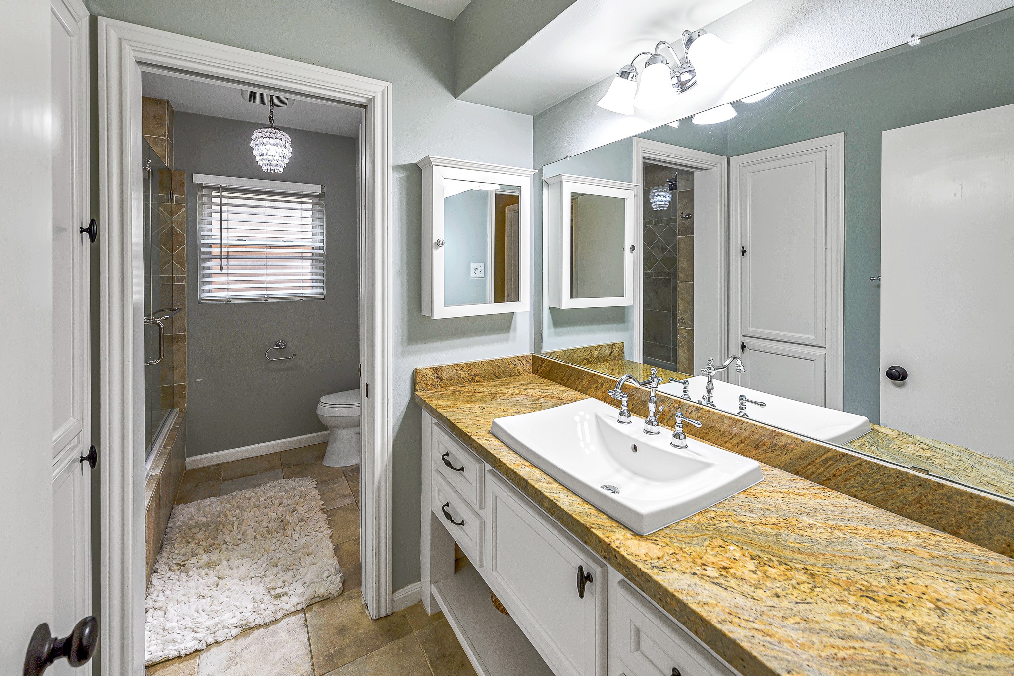 The Hollywood style bathroom allows the convenience of seperate sinks and storage areas.