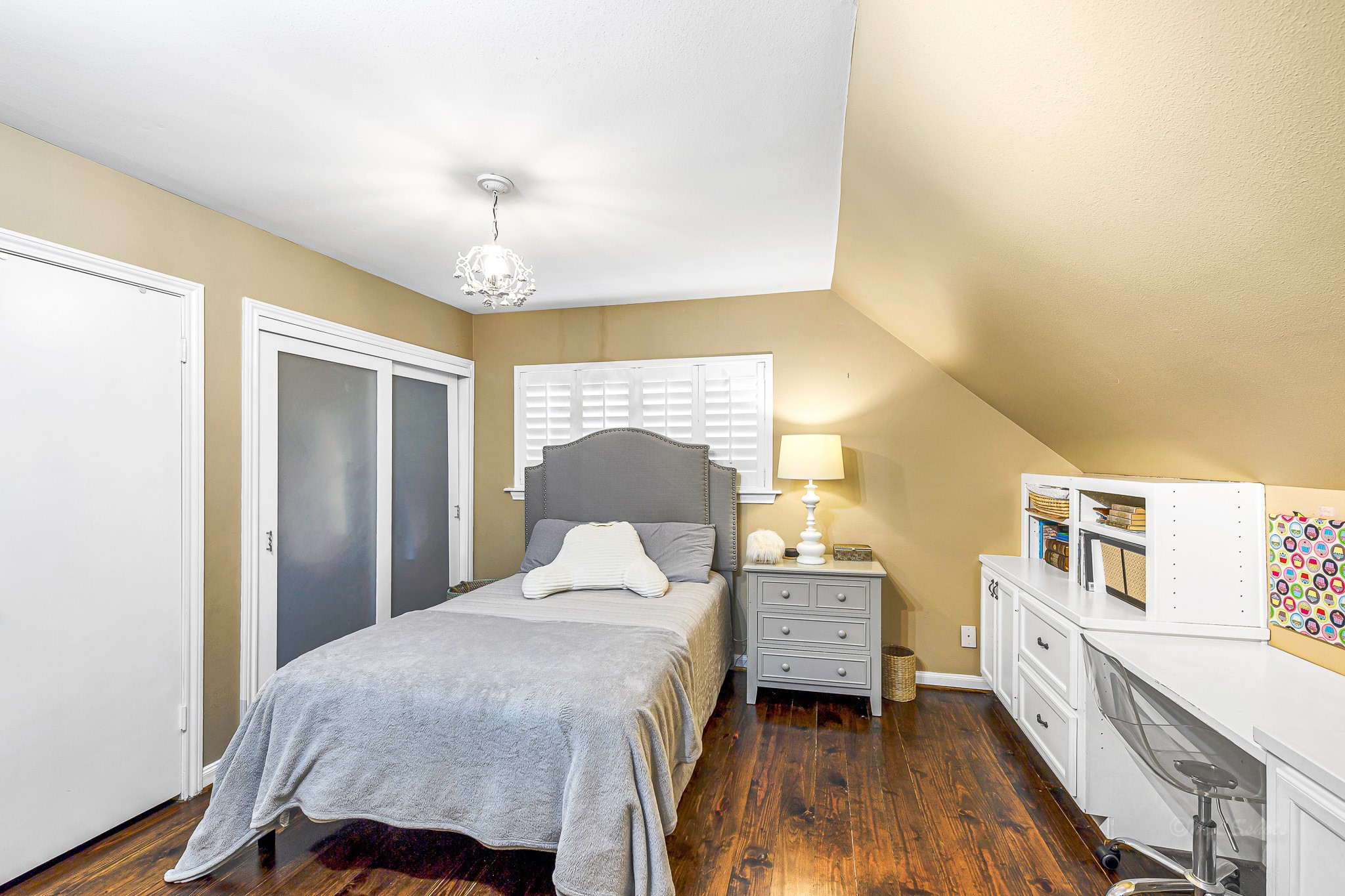 This bedroom is designed for both relaxation and organization. The double closets provide ample storage space, while the custom built-ins offer an opportunity to keep personal items neatly displayed.